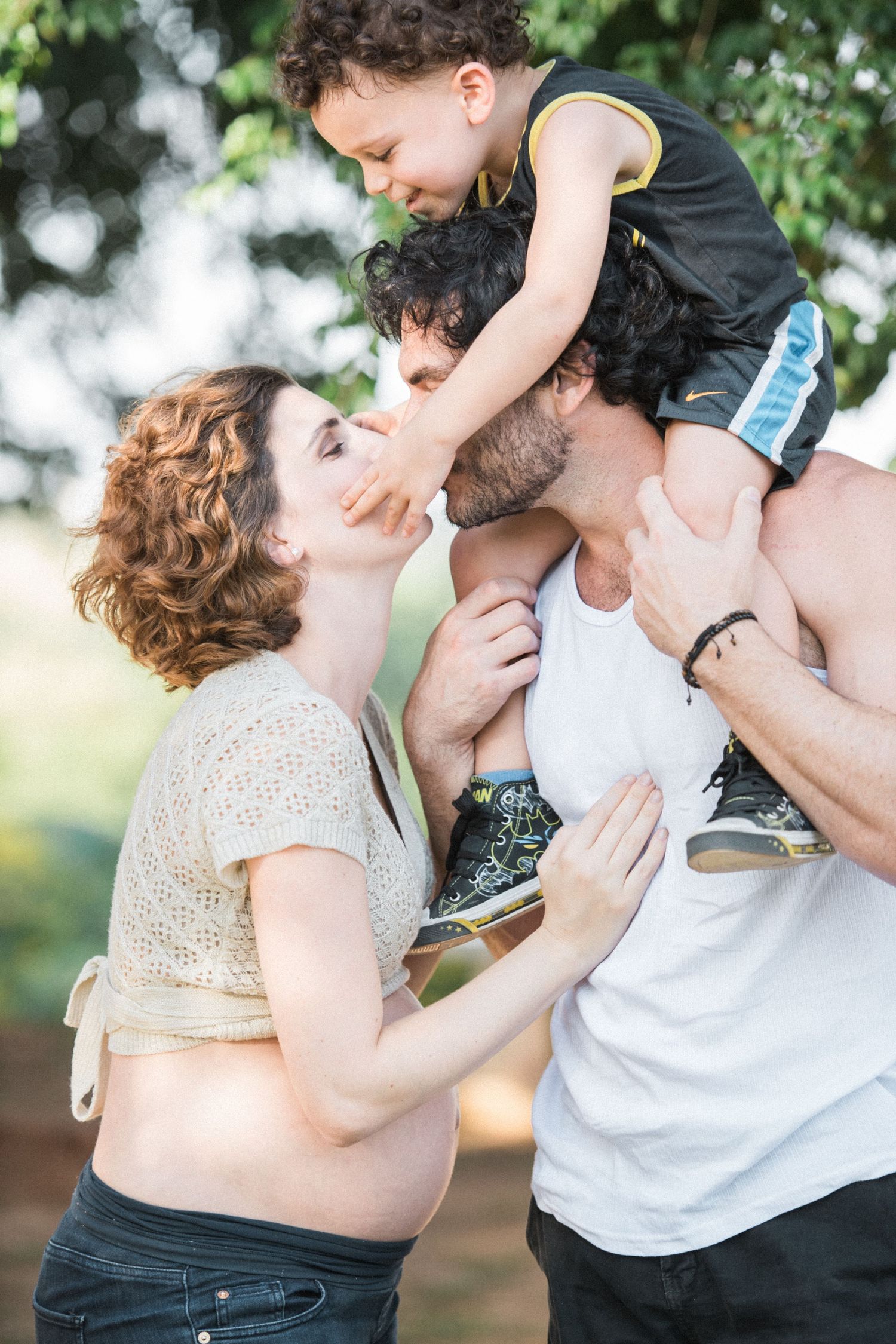 Tender family moments captured in a series of outdoor photos under tree branches.