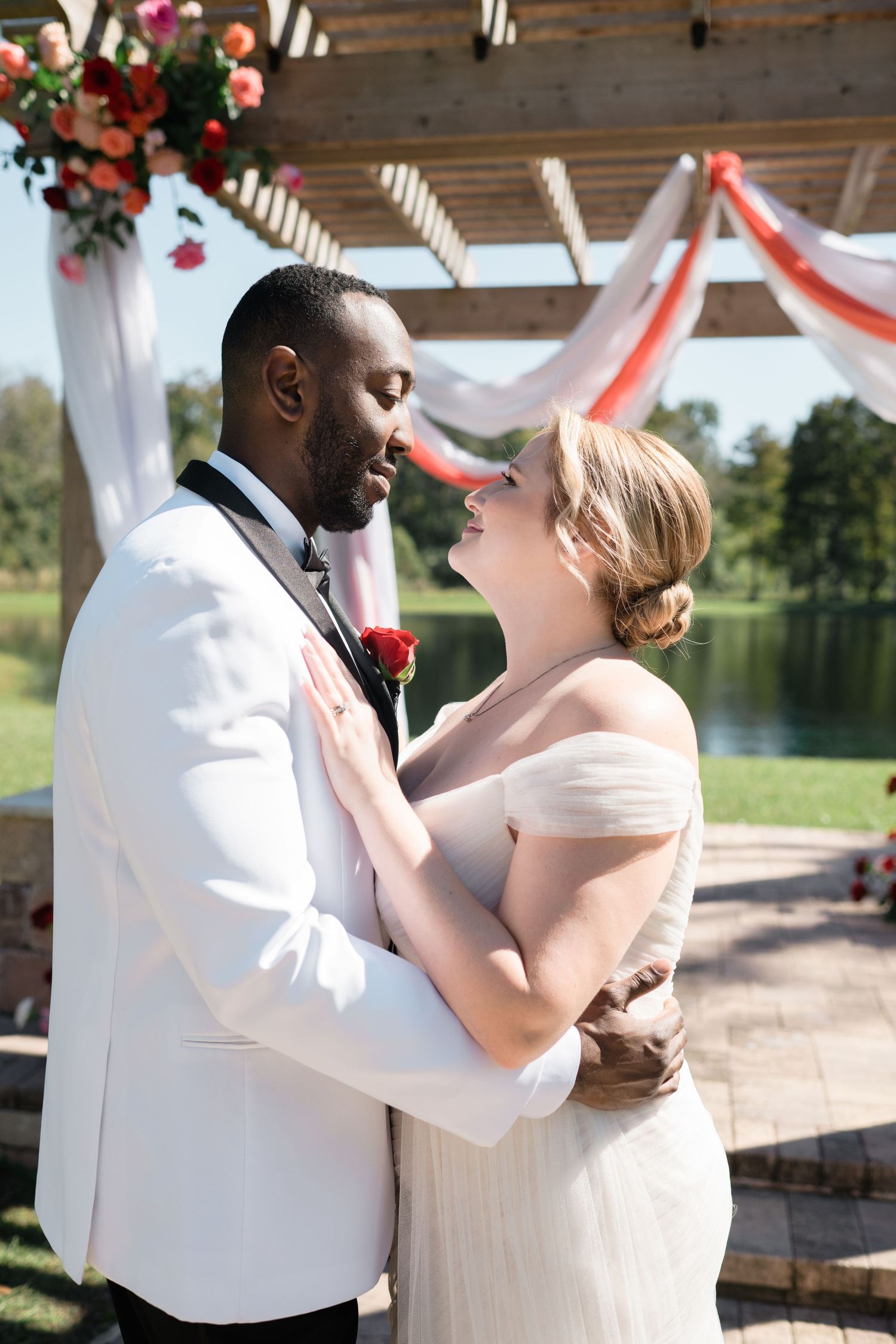 A tender moment between newlyweds during their outdoor wedding ceremony.