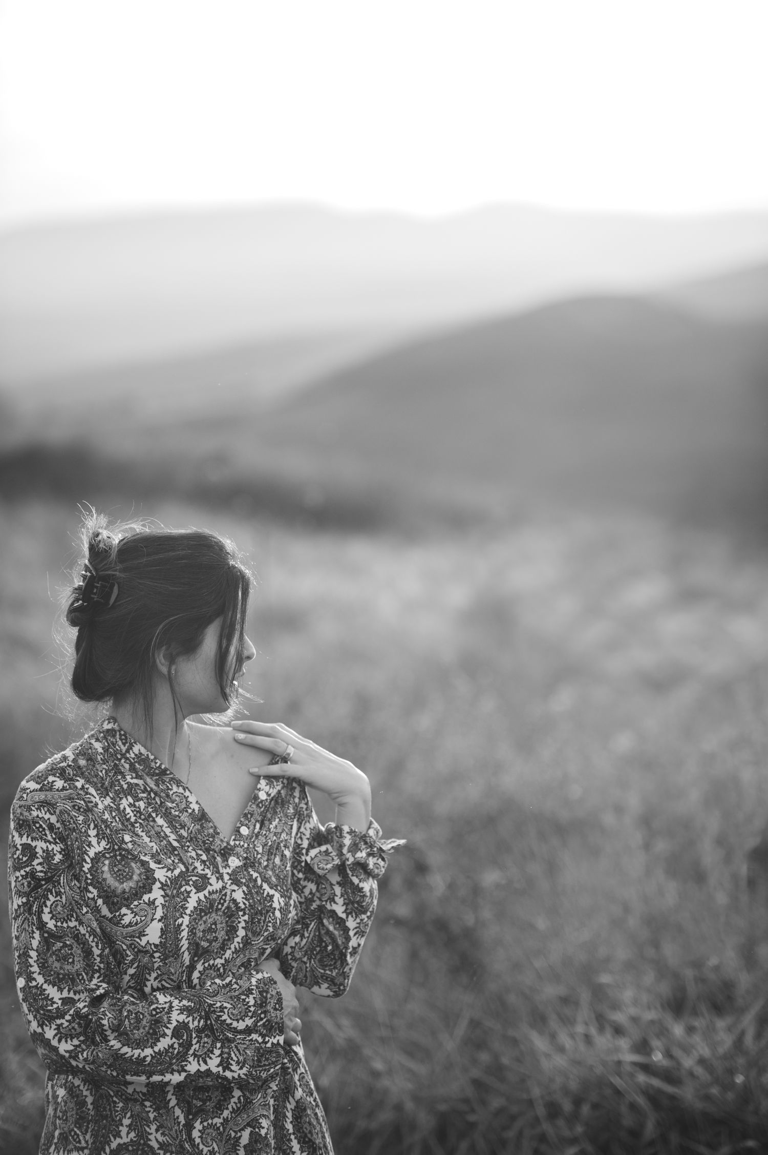 Black and white portraits in mountain field with dramatic lighting.