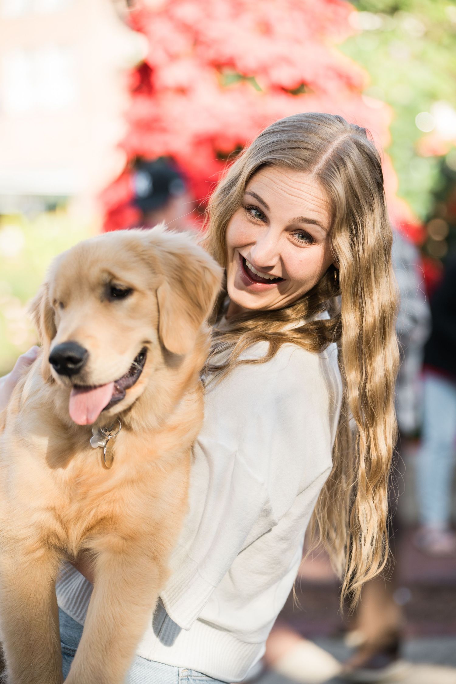 A golden retriever and person share affectionate moments during a photo session.