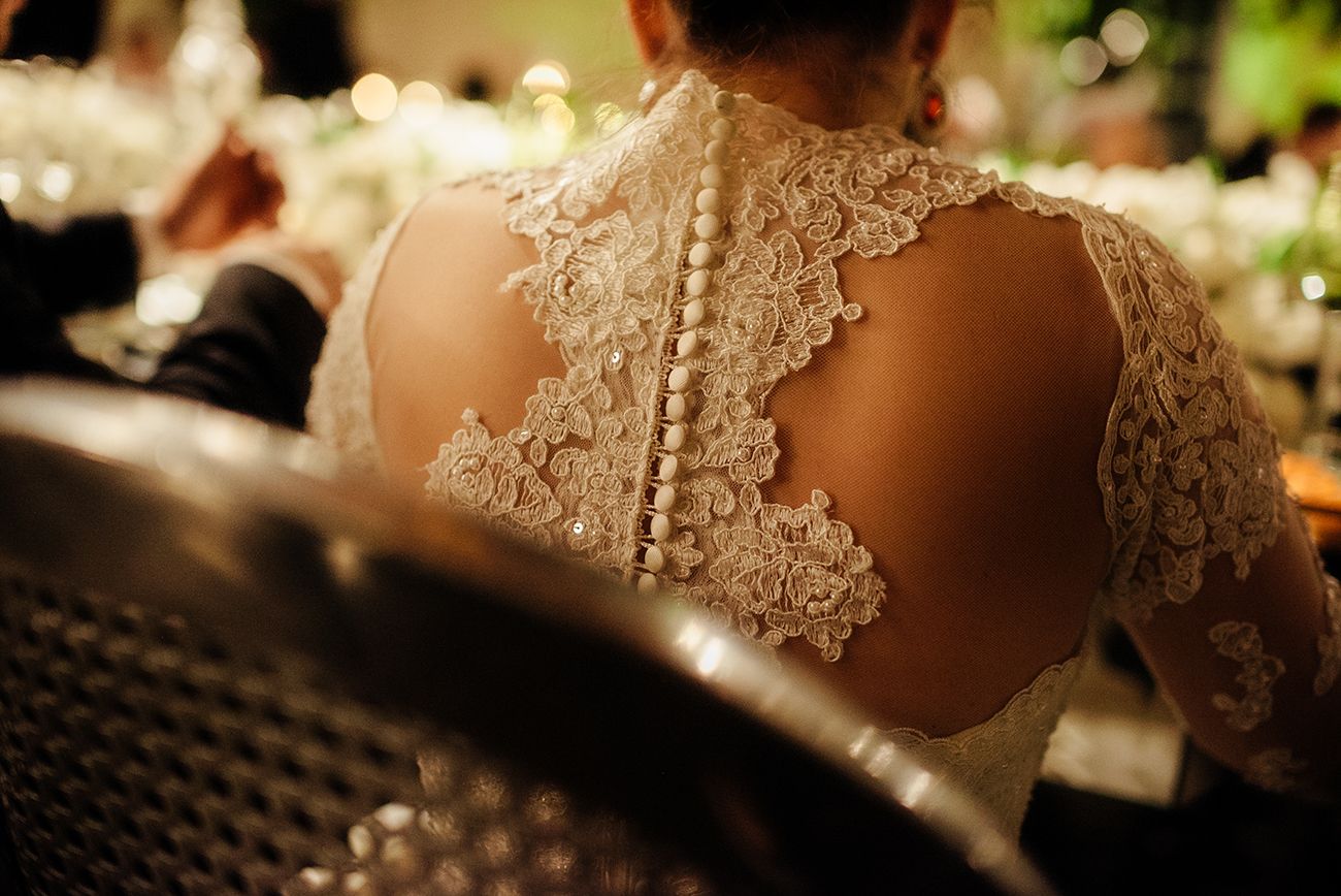 Close-up detail of delicate lace wedding dress fabric with intricate patterns.