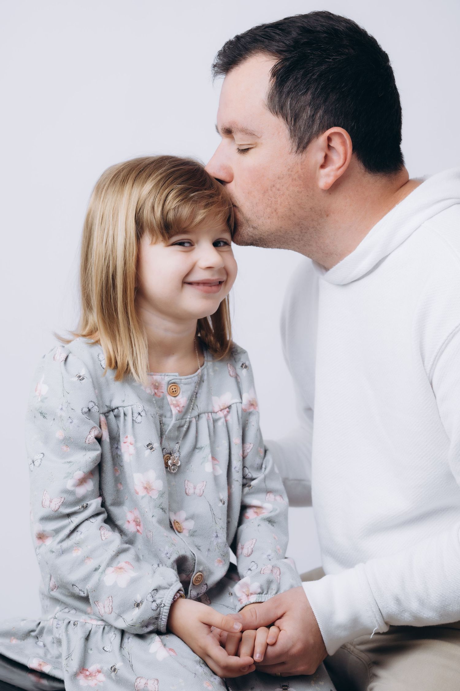 Heartwarming family portrait series showing father-daughter interaction.