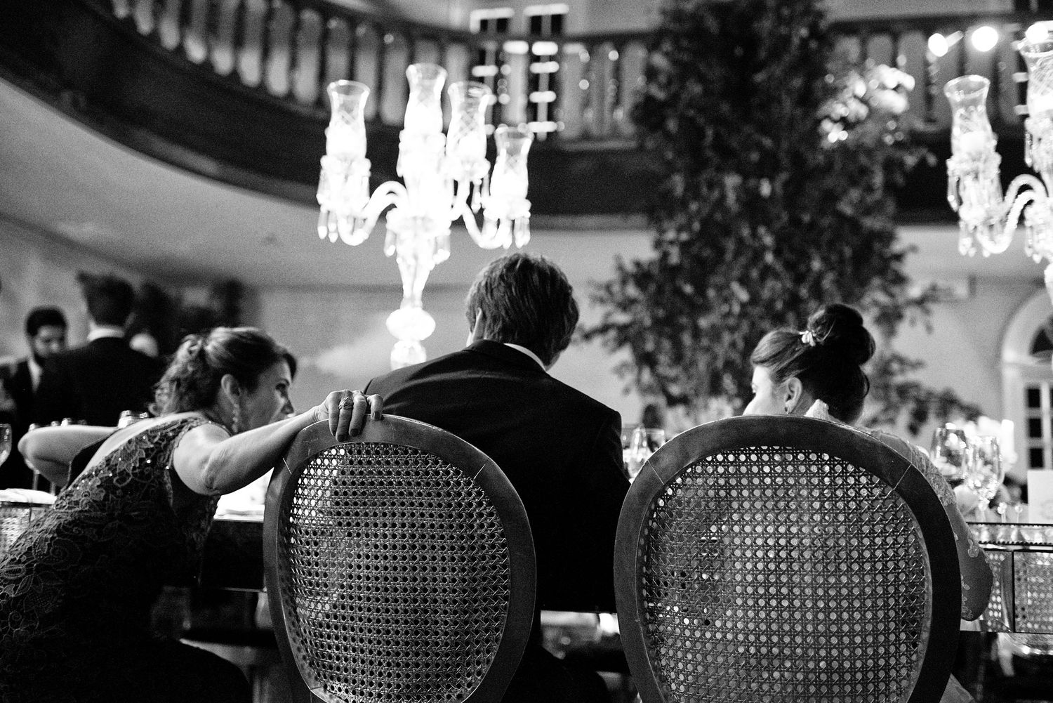 Wedding reception venue with elegant vintage chairs and ambient lighting.