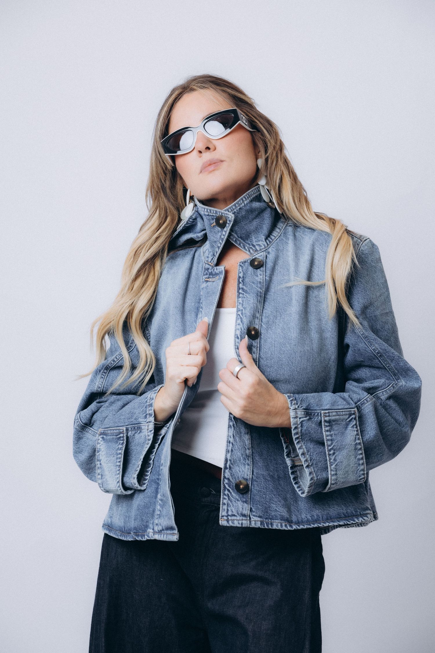 Fashion portrait series featuring denim jacket and sunglasses against white backdrop.