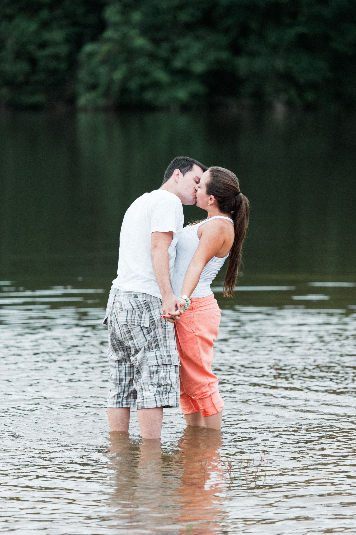 Romantic moment captured in knee-deep lake water.
