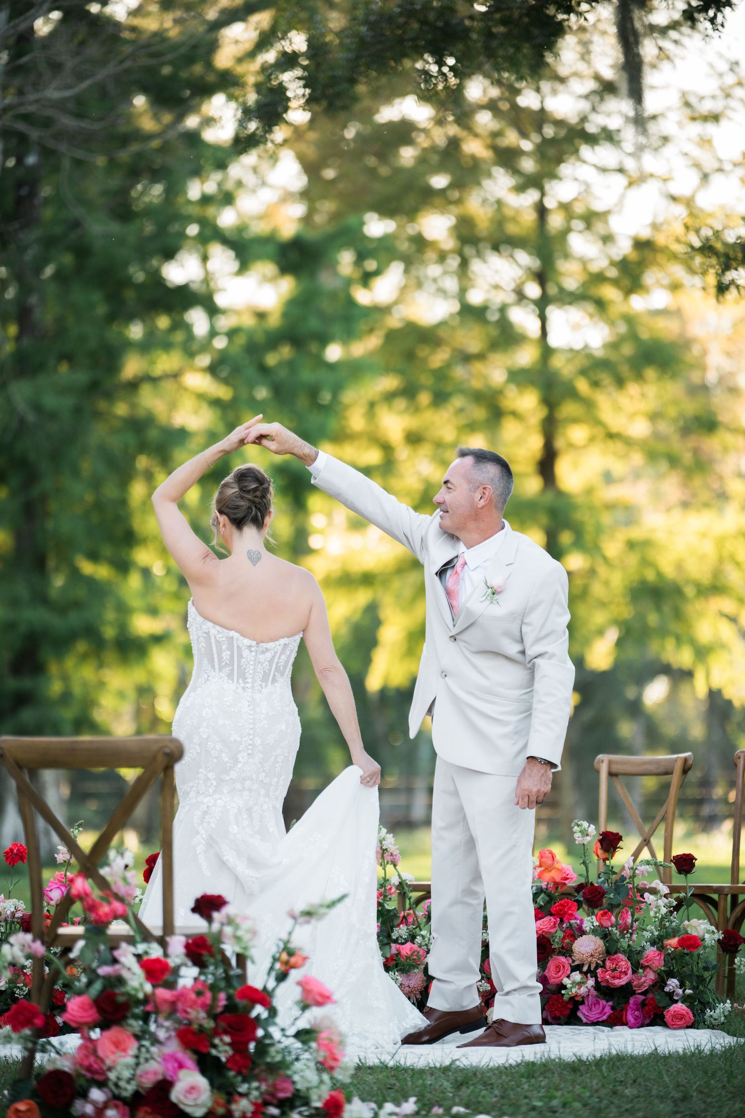 A romantic dance sequence in a garden setting with pink and red floral decorations.