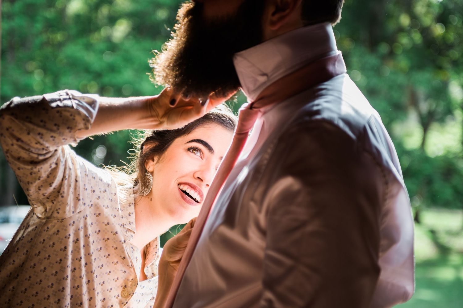 Joyful wedding celebration moment captured in natural outdoor setting.