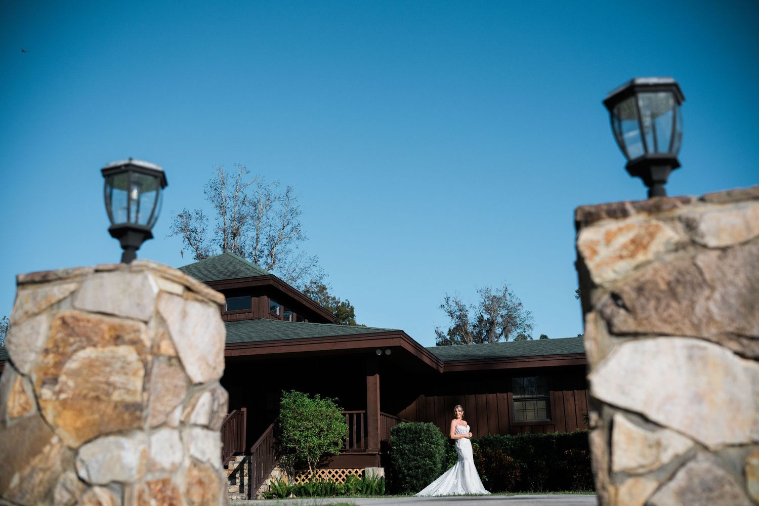 Stone wall and outdoor venue with rustic architectural details against a blue sky.