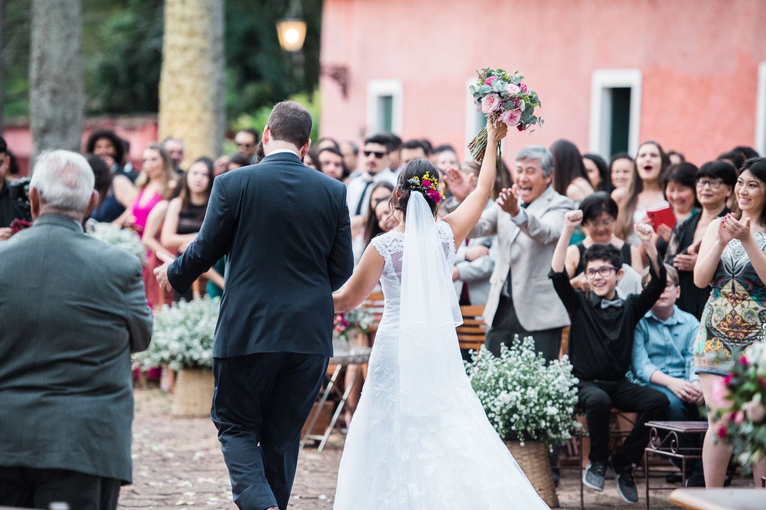 Wedding guests gather on a beautiful outdoor patio during a celebration.