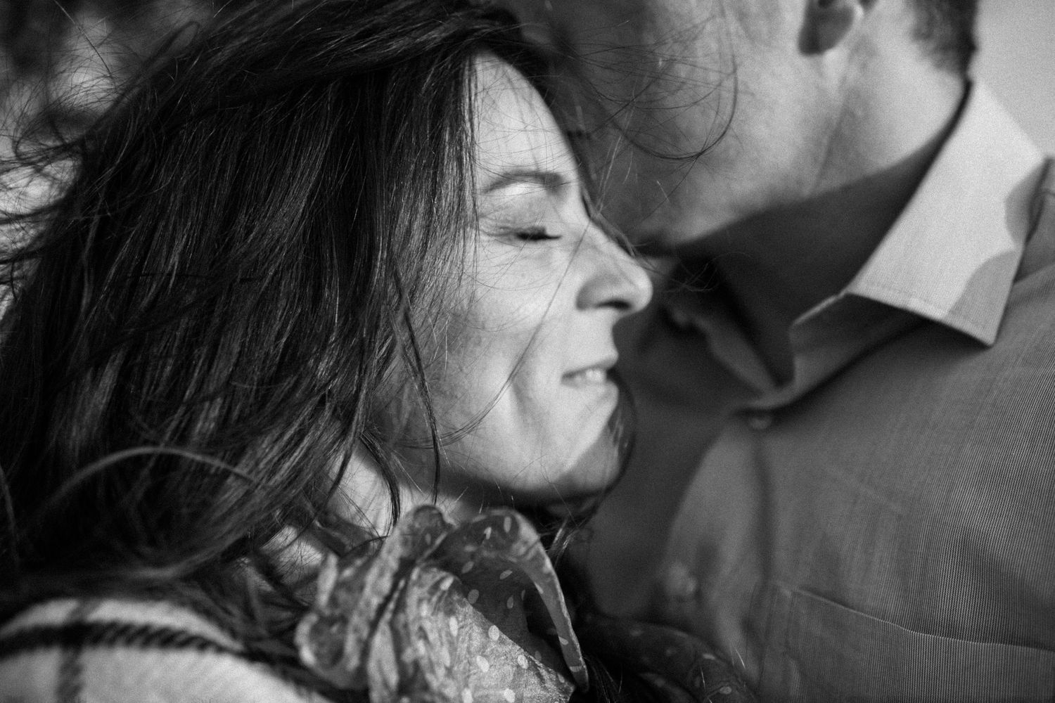 Intimate black and white close-up shot with soft natural lighting.