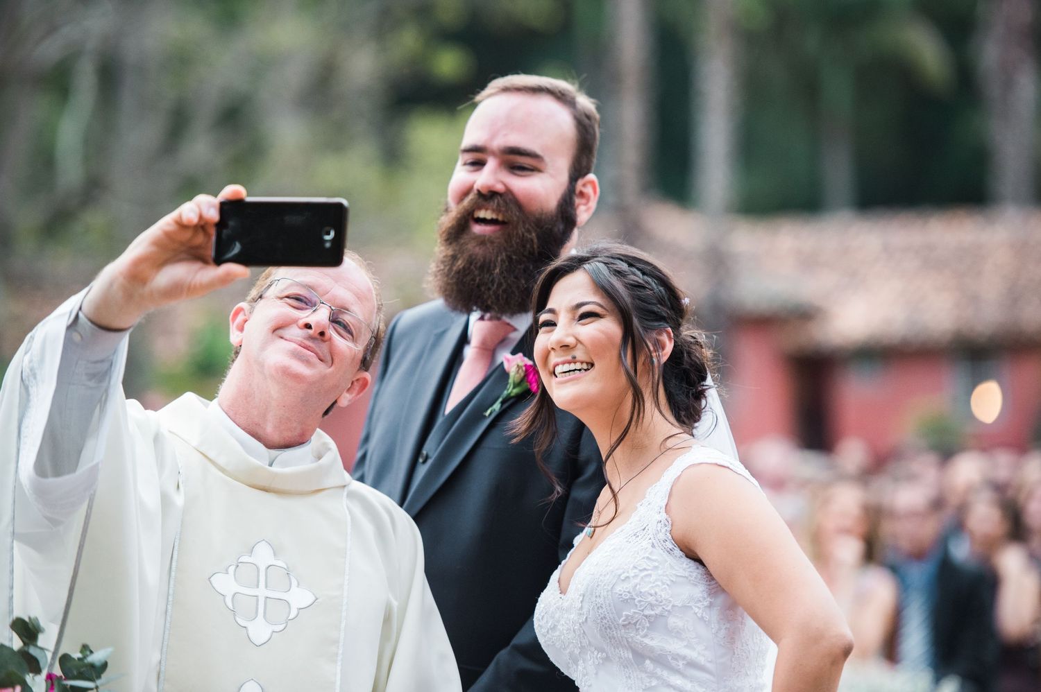 Candid wedding moments captured during an outdoor ceremony with guests in attendance.