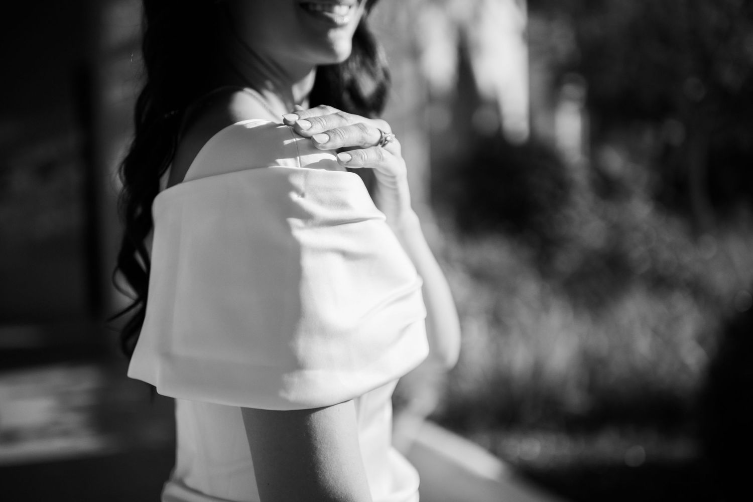 Artistic black and white close-up of woman's profile in white top.