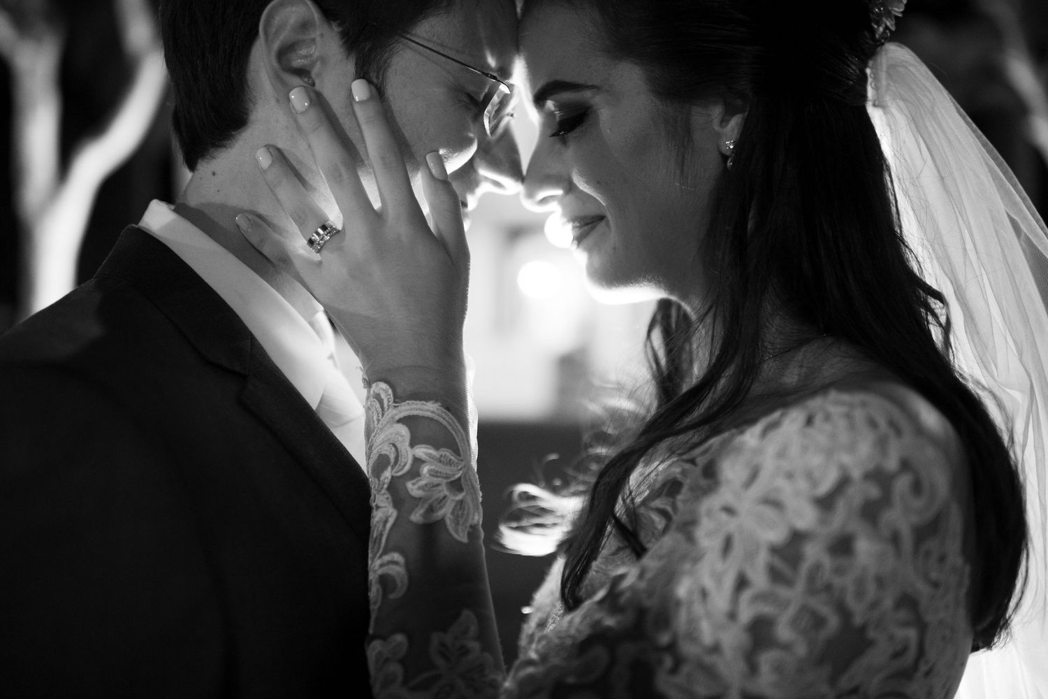 Romantic black and white wedding photos showing intimate moments between newlyweds during their celebration.