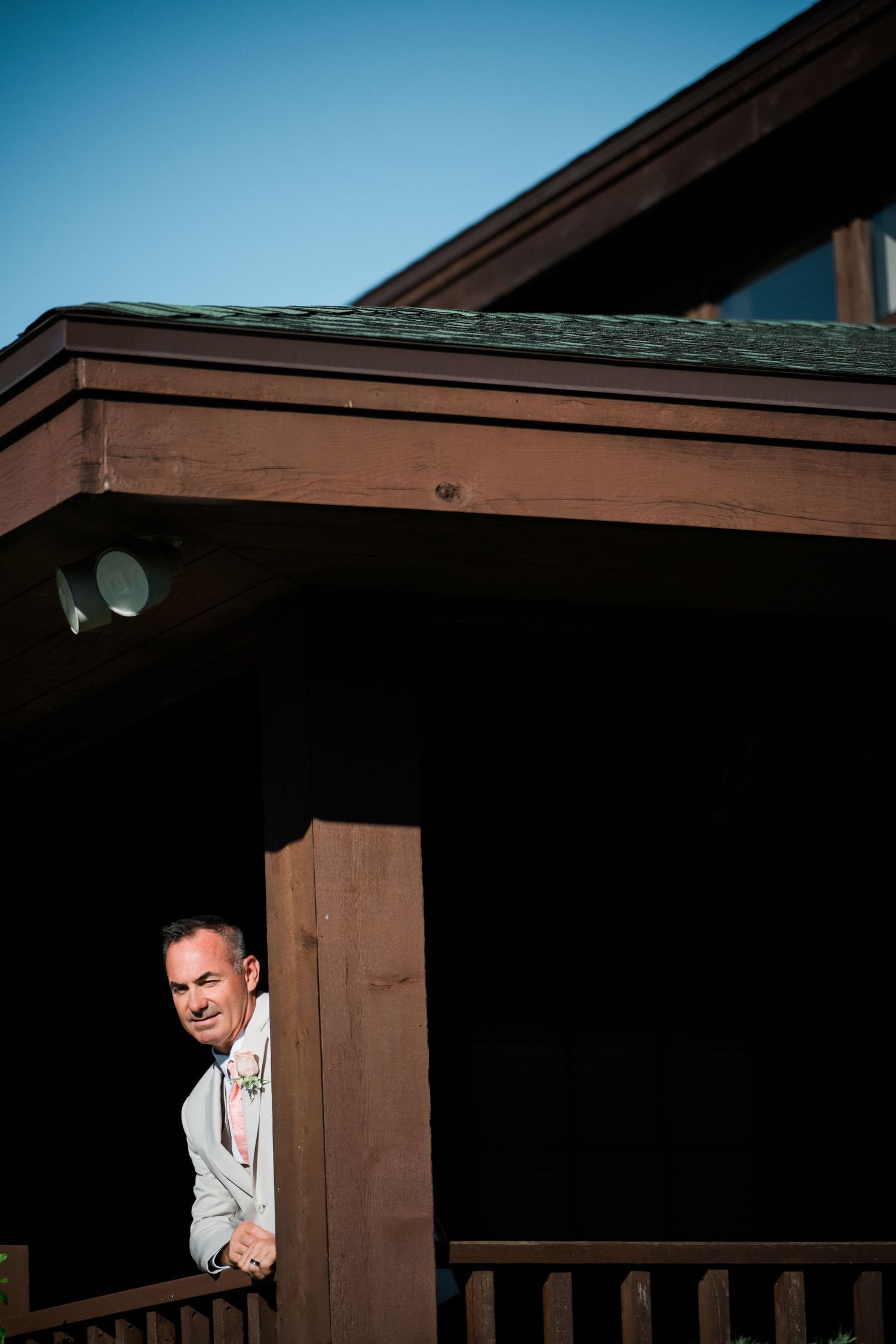 Playful moment captured at a wooden venue with architectural details.