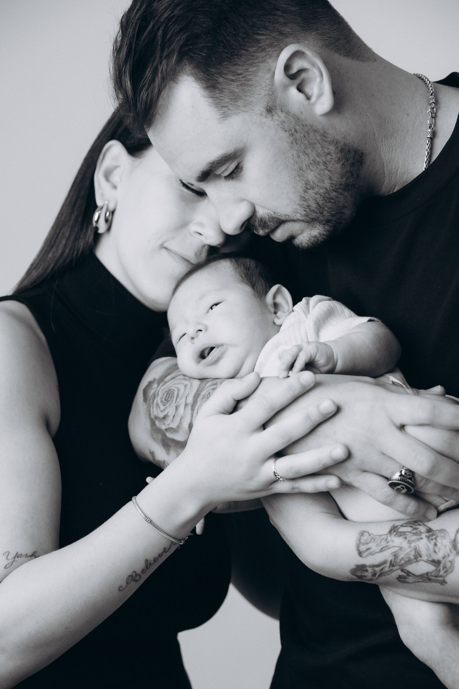 Black and white close-up photos capturing tender moments between parent and child.