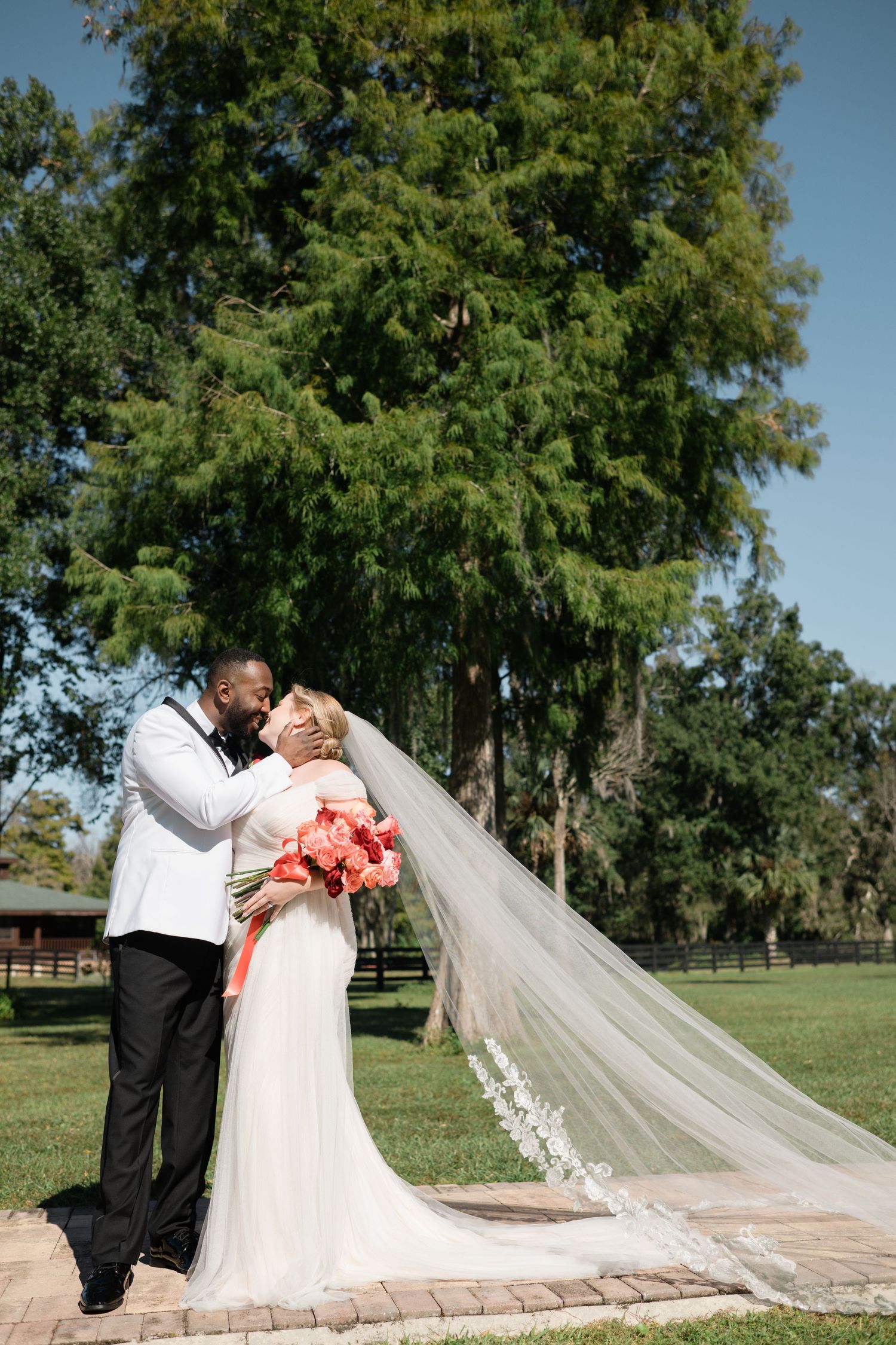 Wedding couple sharing romantic moments on their special day in a garden setting.