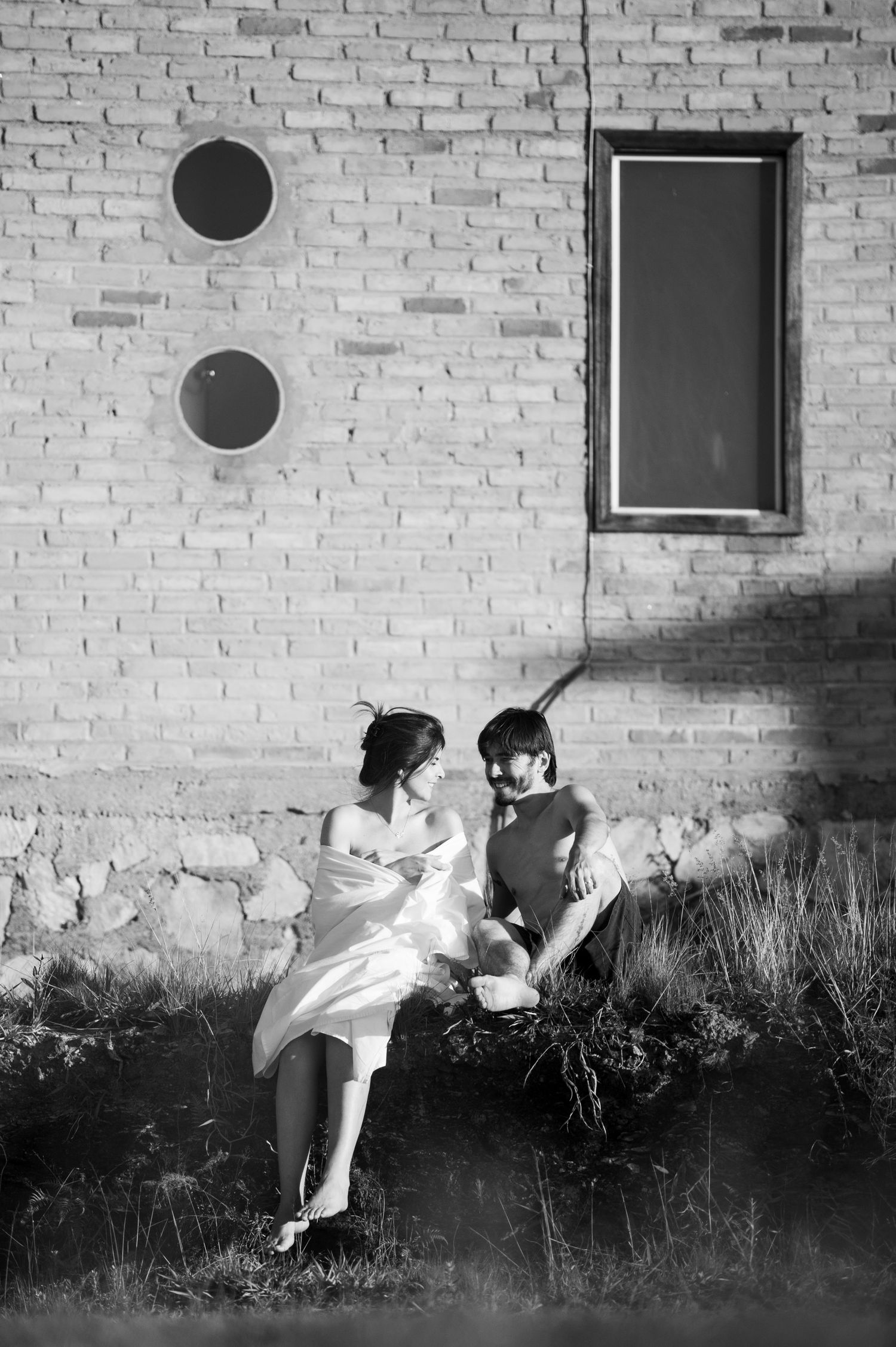 Black and white sequence showing figure levitating against brick wall.