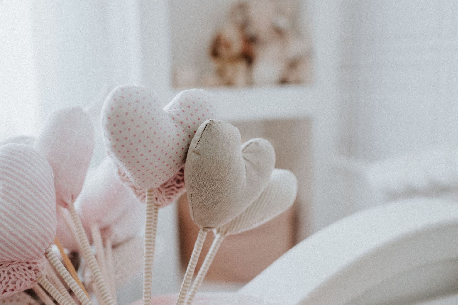 Soft focus decorative white balloons creating dreamy nursery atmosphere.