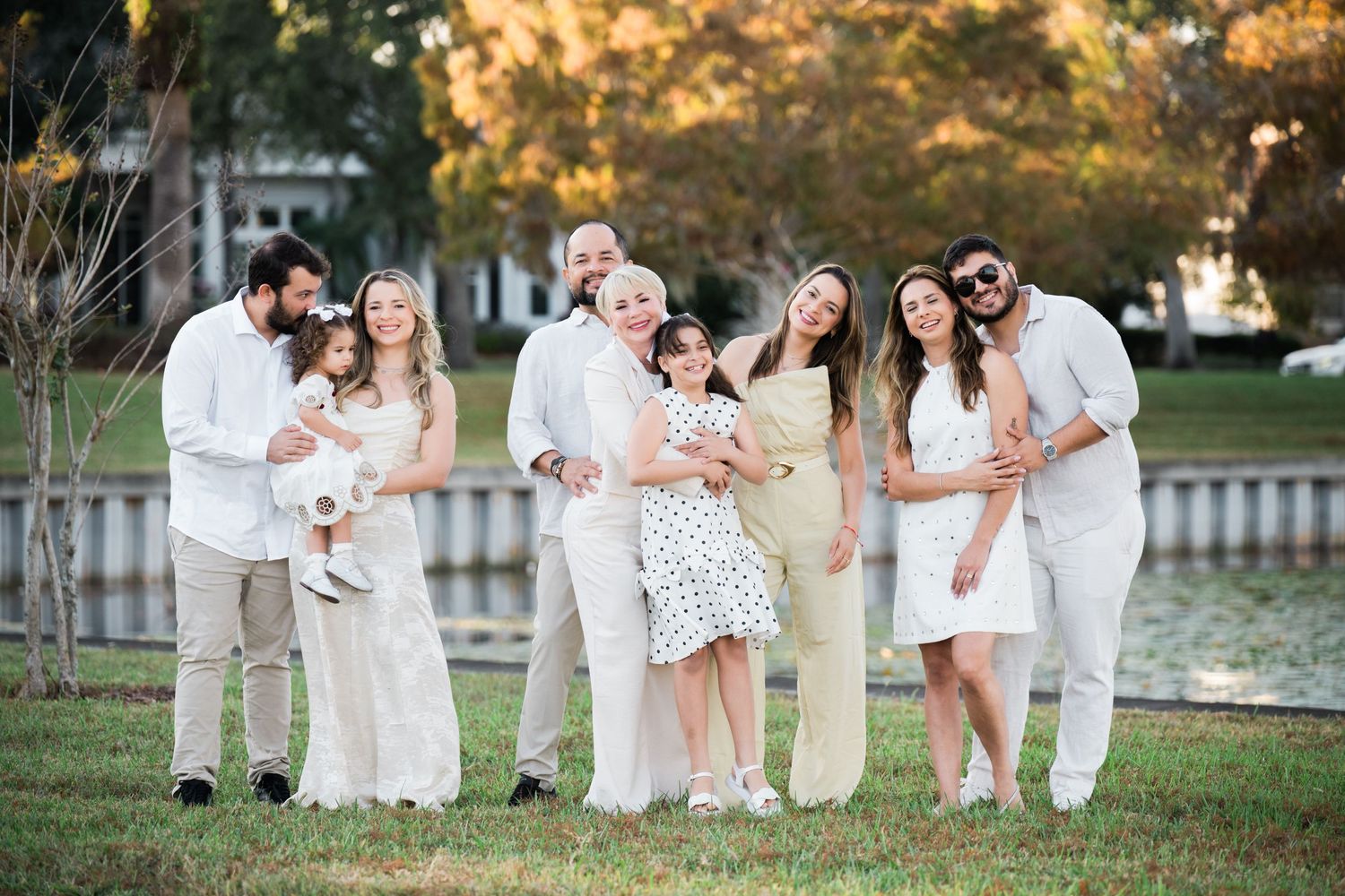 Casual group portrait with everyone dressed in white enjoying a fun moment together.