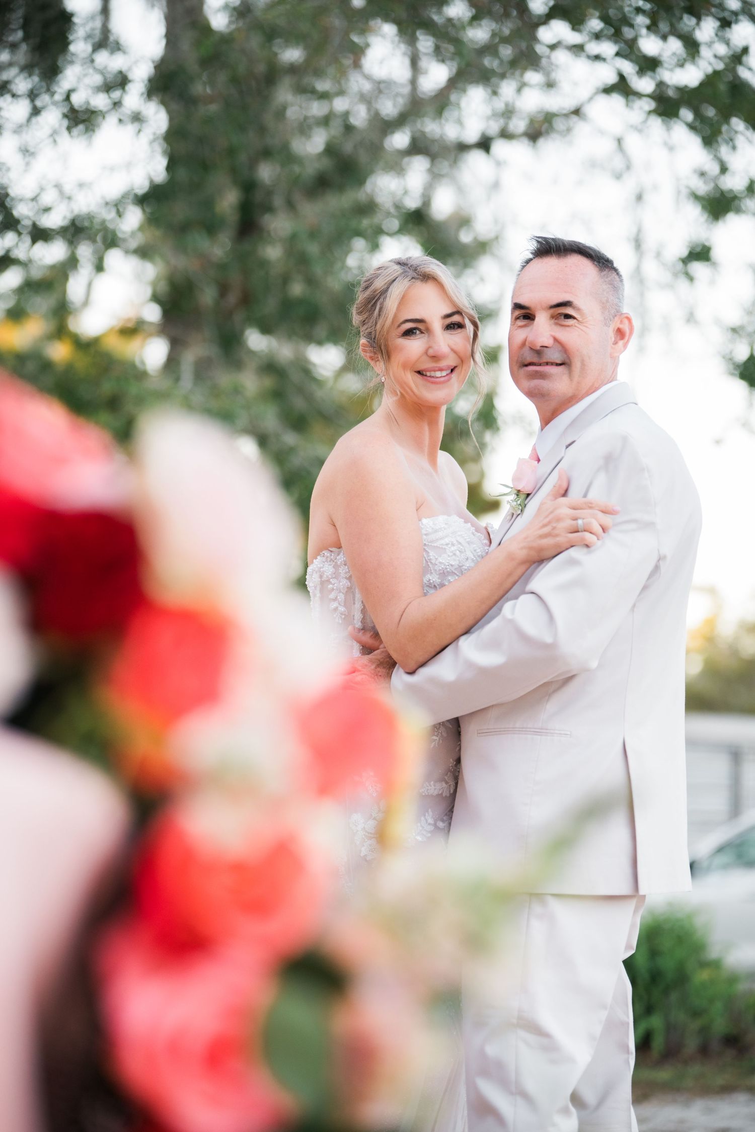 A romantic wedding photo sequence showing a couple dancing outdoors with soft lighting and floral elements.