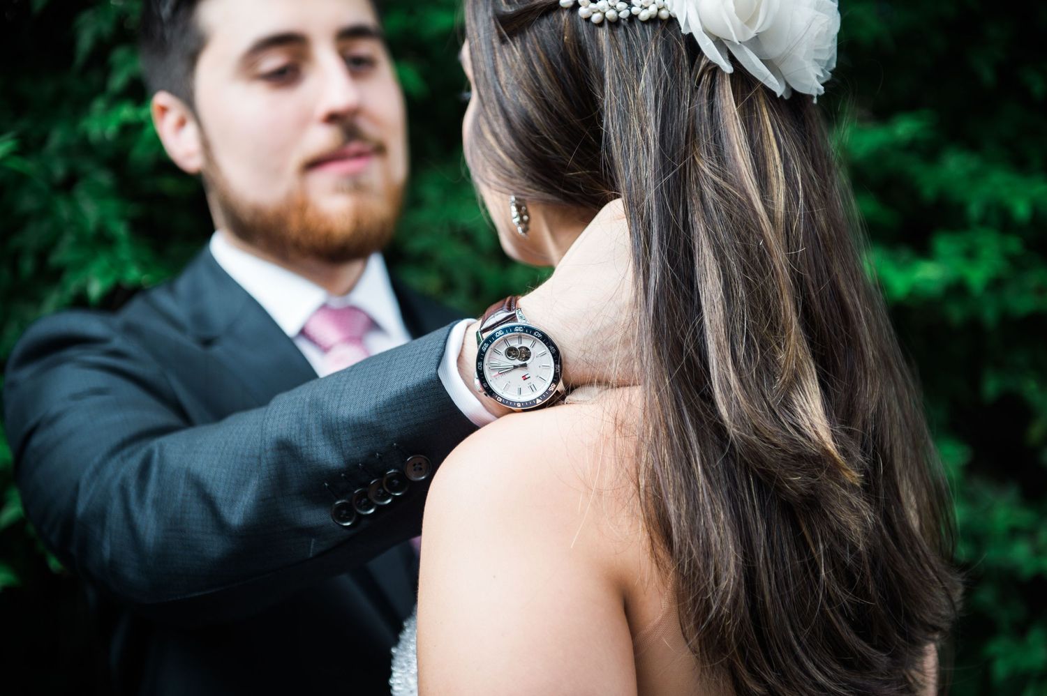 Intimate wedding portraits showing tender moments between newlyweds in garden setting.