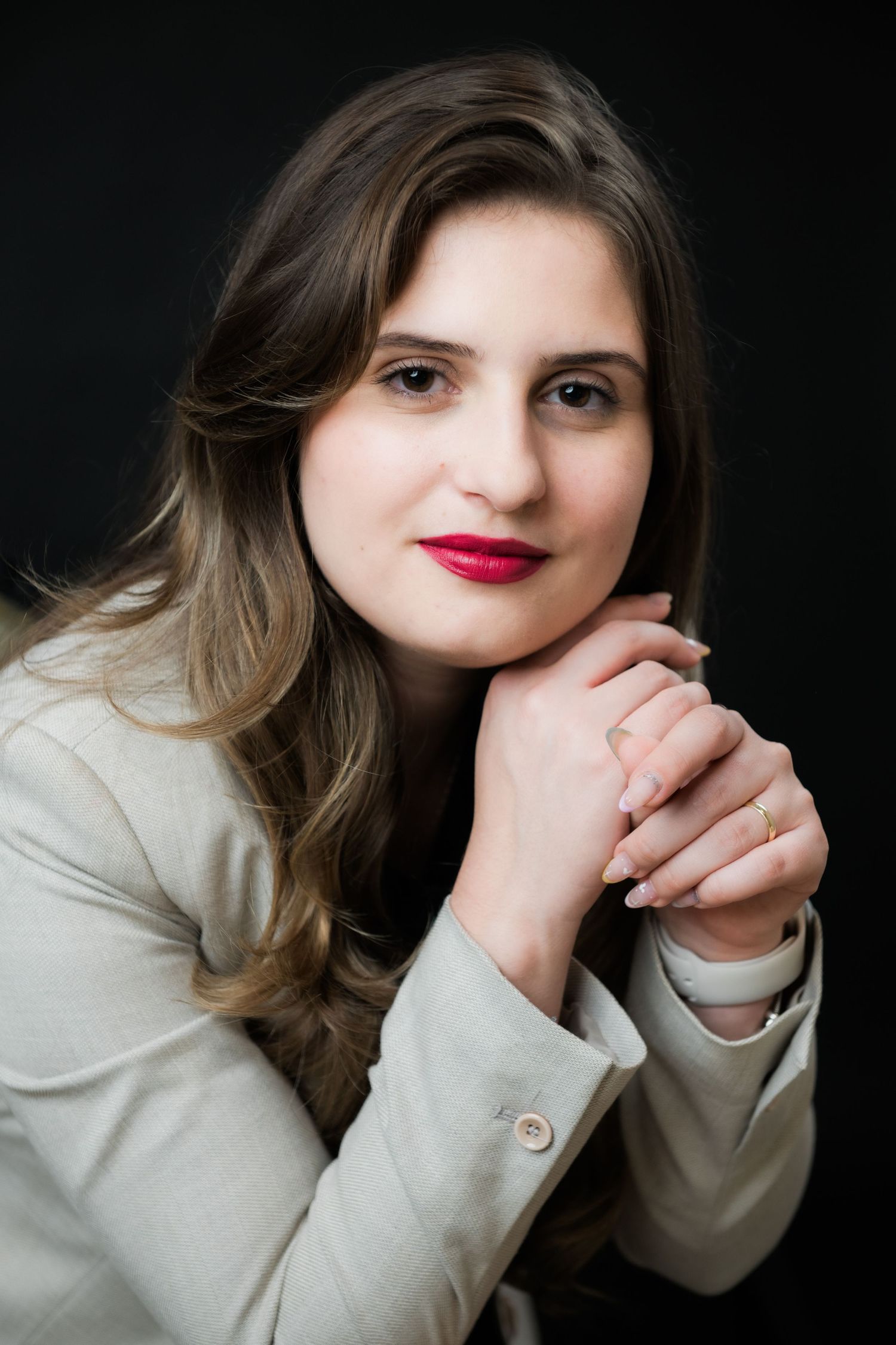 A series of moody portrait shots showing someone in a white sweater against a dark background with red lipstick.