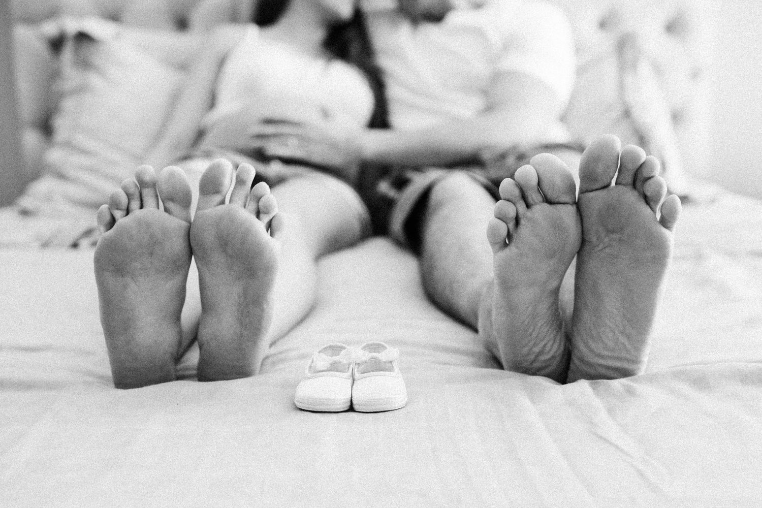 Black and white photo series showing baby feet and toes on white bedding.