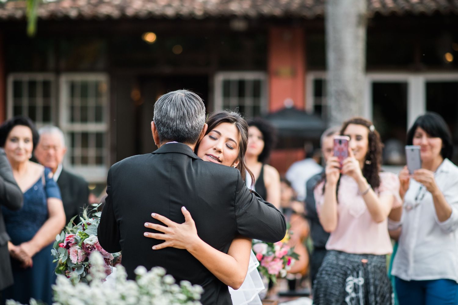Emotional wedding ceremony moments captured at a rustic outdoor venue.
