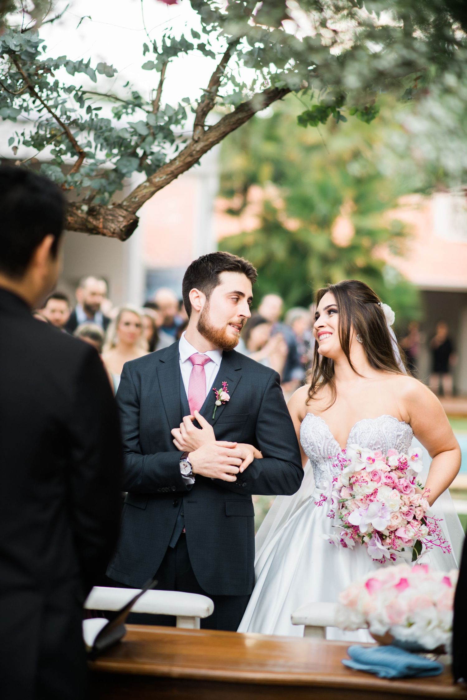Newlyweds share an intimate moment during their outdoor wedding ceremony.