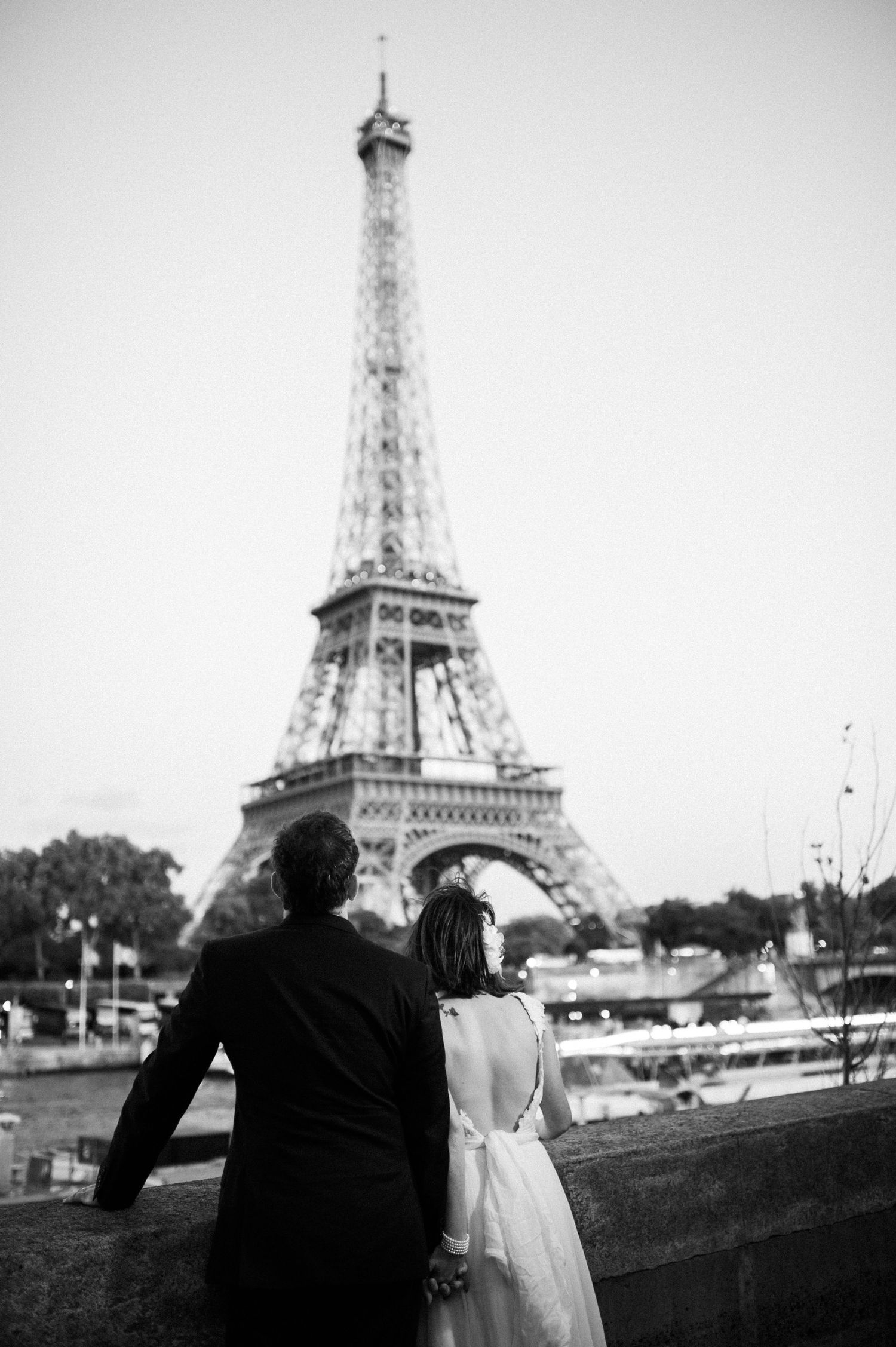 Romantic wedding couple silhouetted against the Eiffel Tower in Paris.