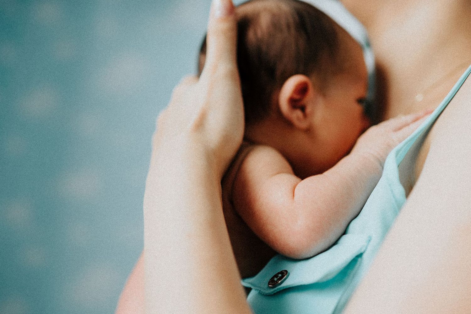 Intimate close-up shots of mother and newborn bonding moments.