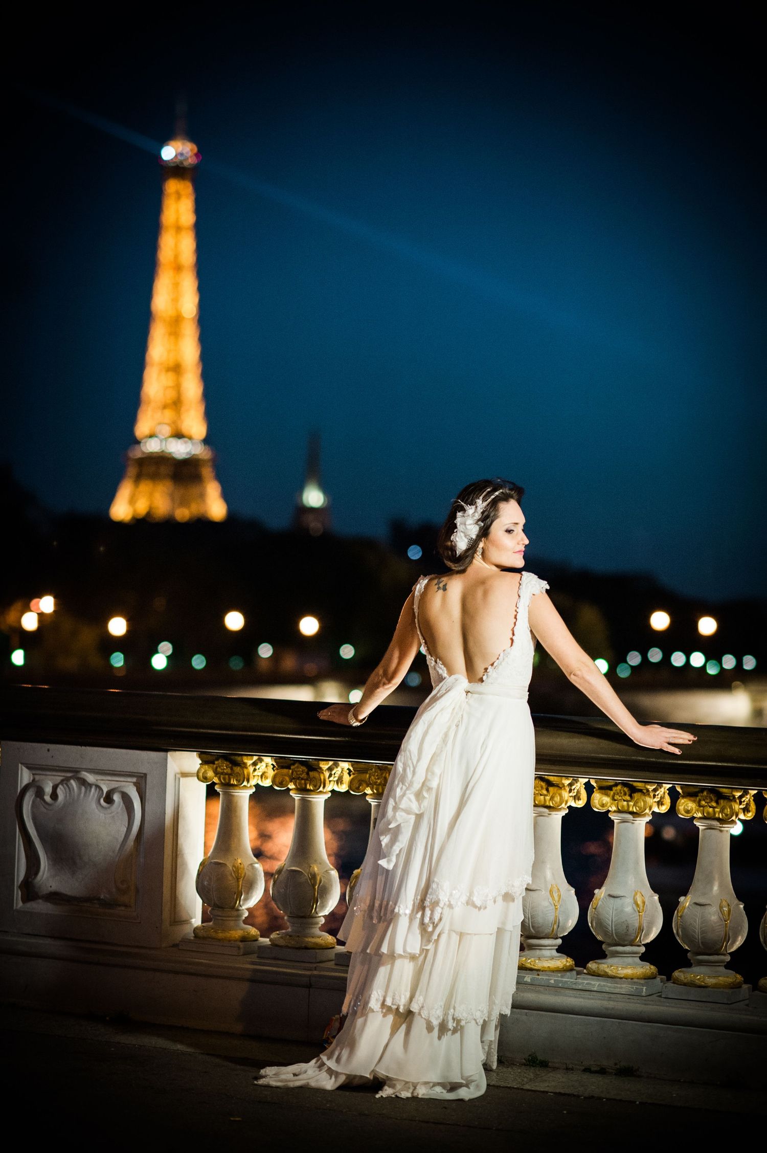 Dramatic nighttime bridal portraits with the illuminated Eiffel Tower in Paris.