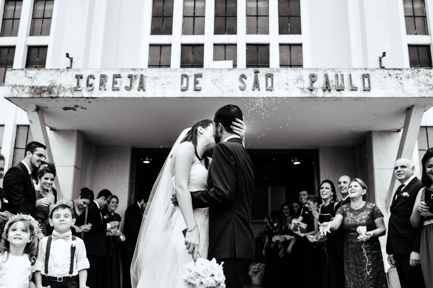 Wedding ceremony exterior shots of church entrance with gathered guests.