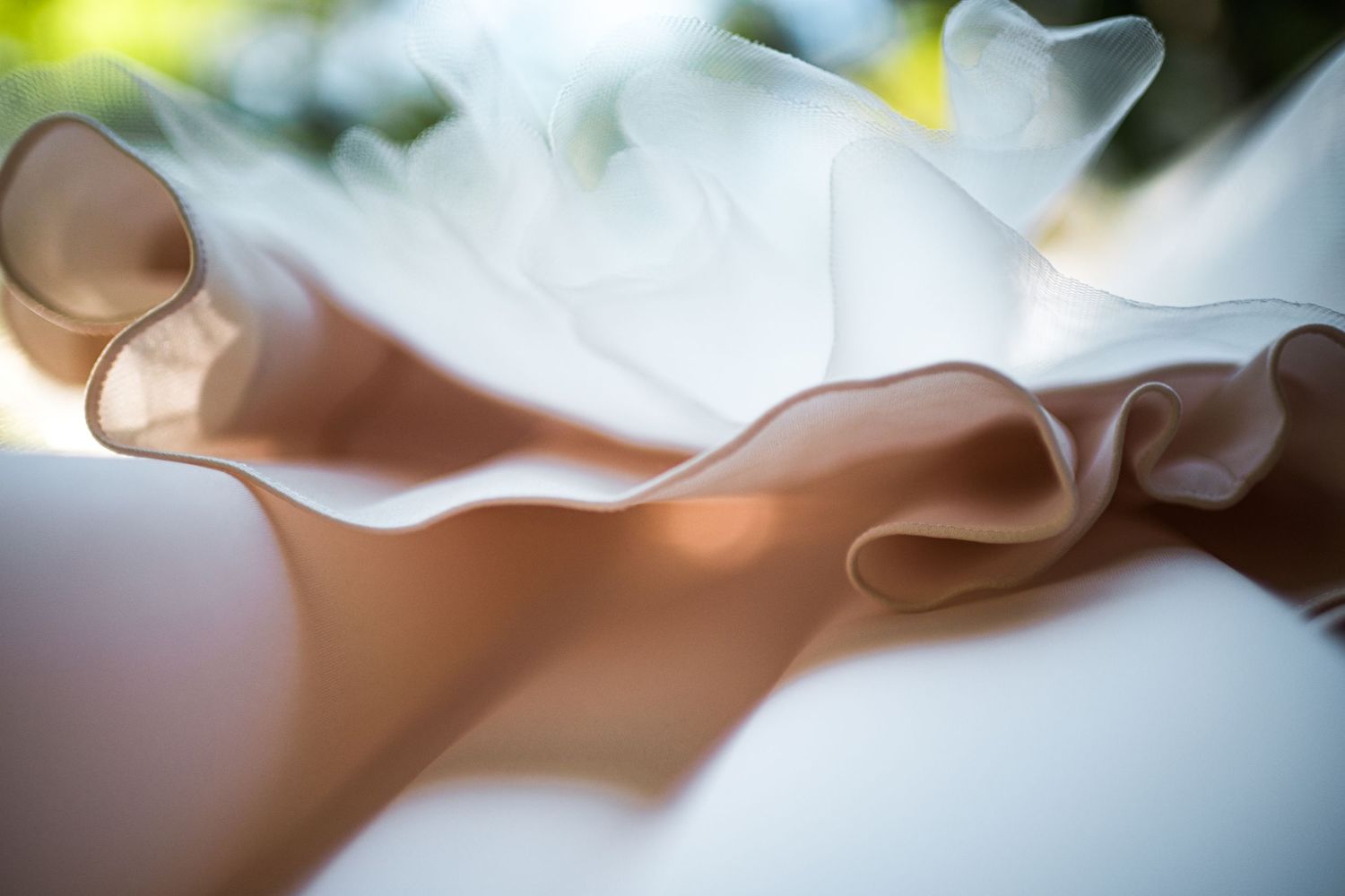 Delicate white fabric details captured in dreamy soft focus.