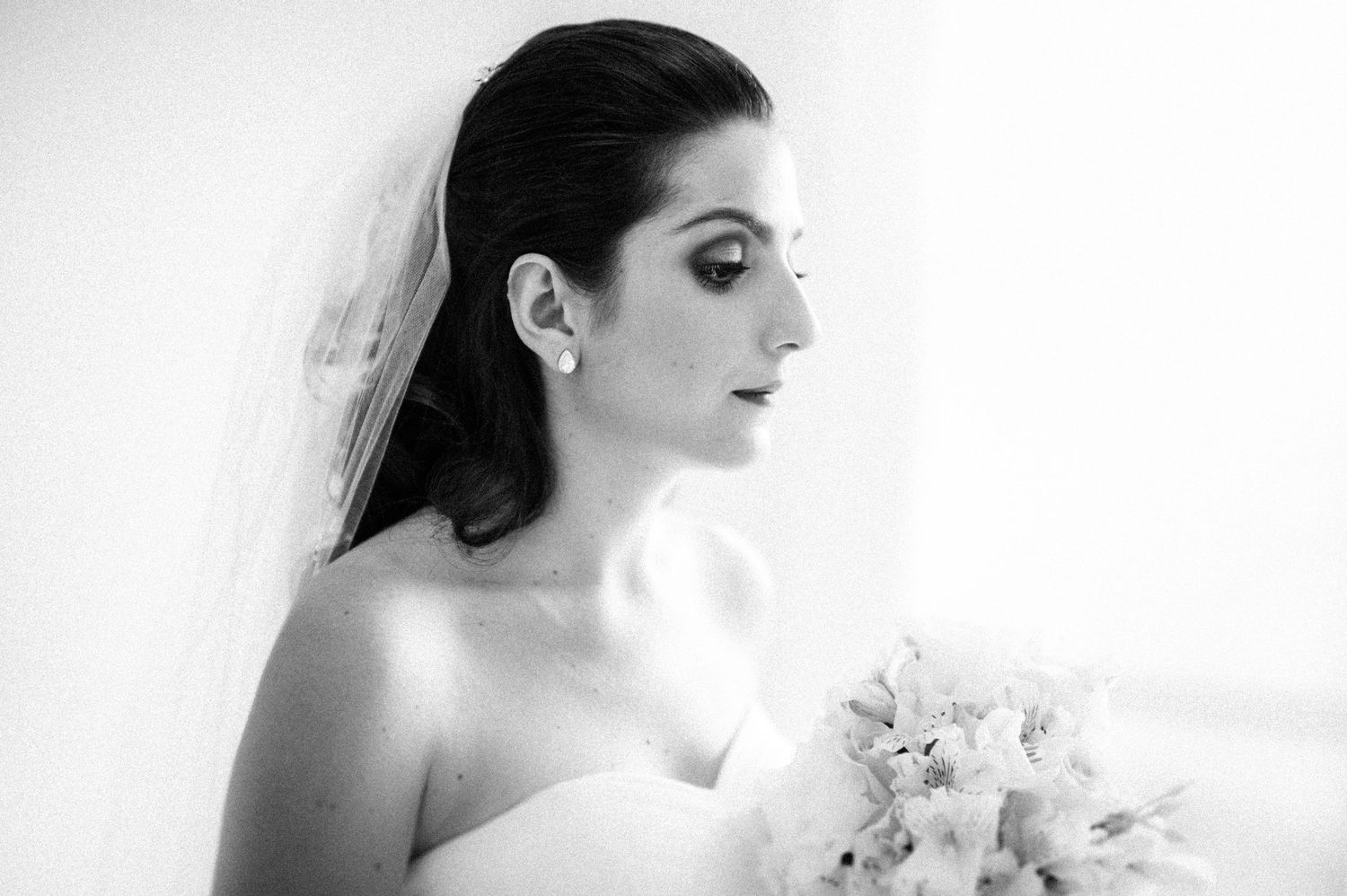 Black and white bridal portraits showing elegant details of wedding dress and veil.