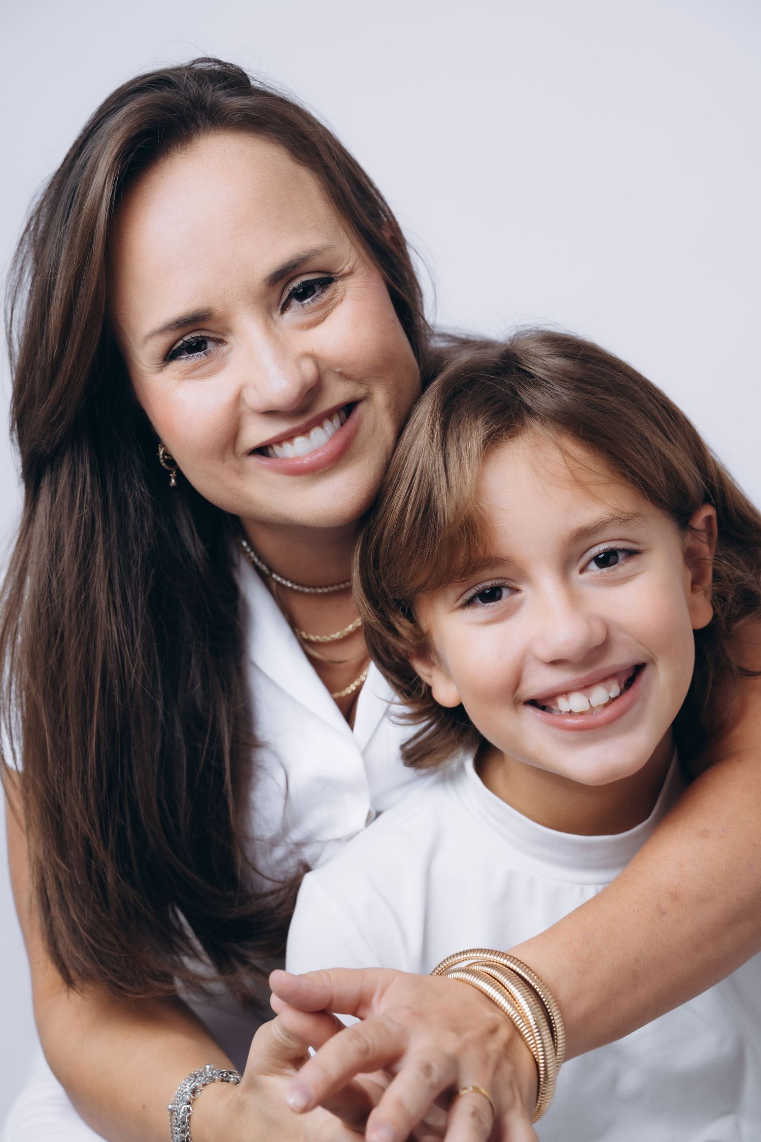 Intimate portrait of two people embracing and smiling warmly at camera.