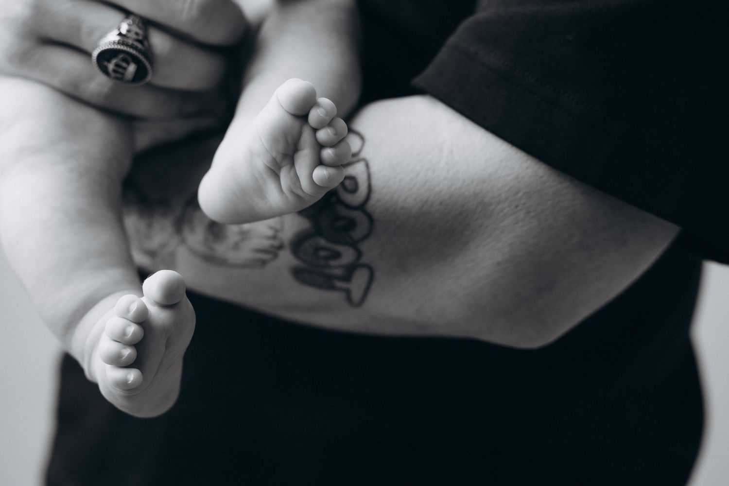 Minimalist black and white photos showing tender moments between parent and baby.