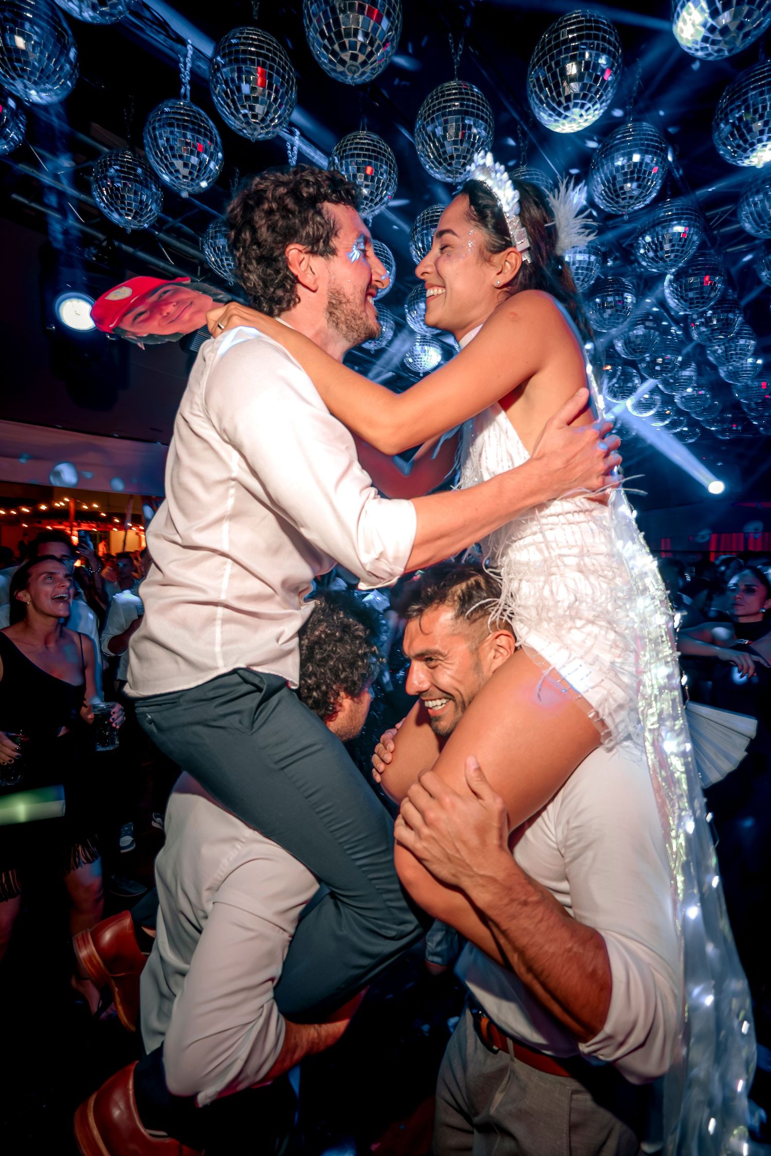 A sequence of dance floor photos showing two people dancing energetically under disco ball lighting at a nightclub party.