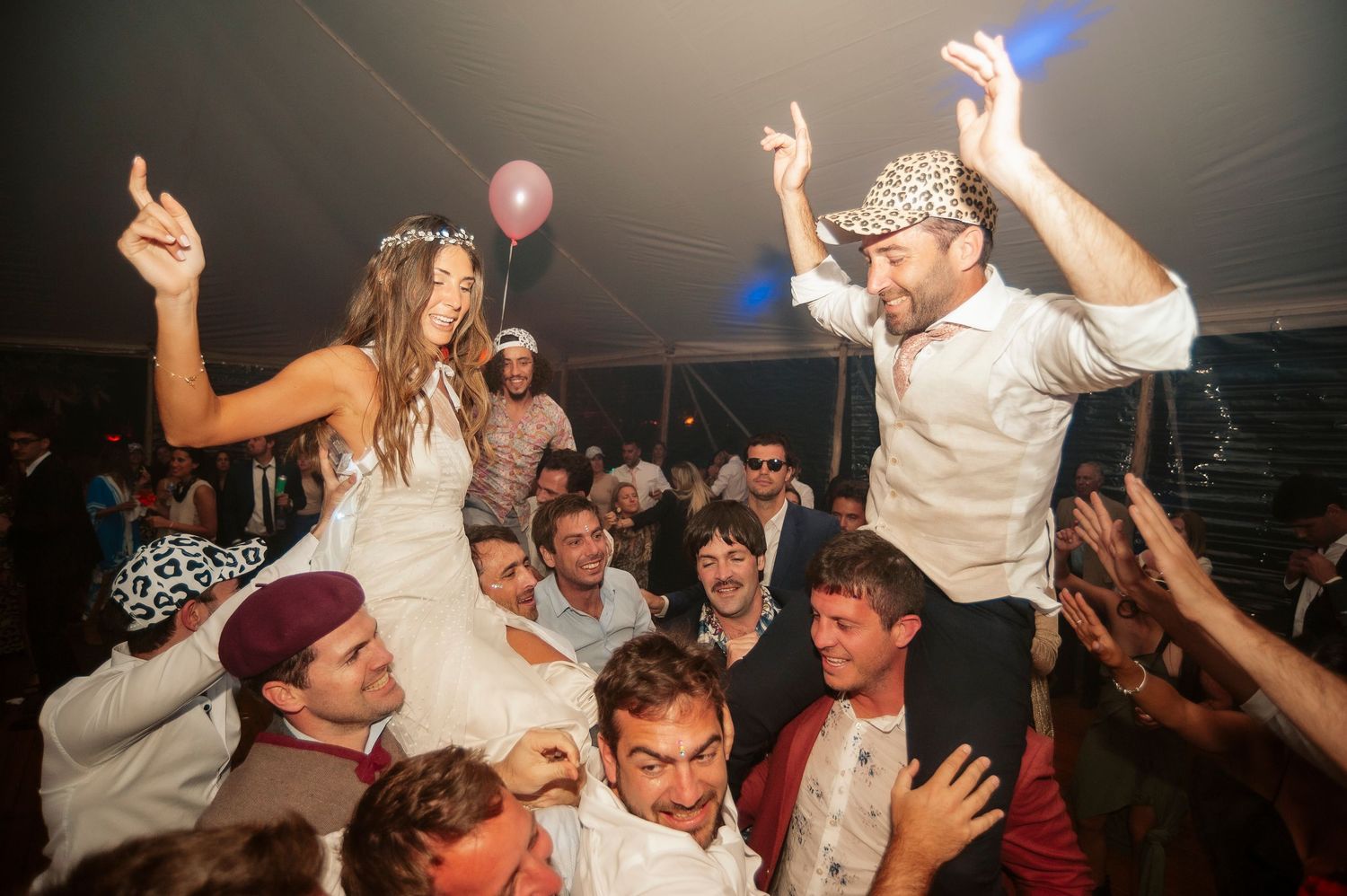 Lively dance party scene with guests celebrating under dimmed lighting.