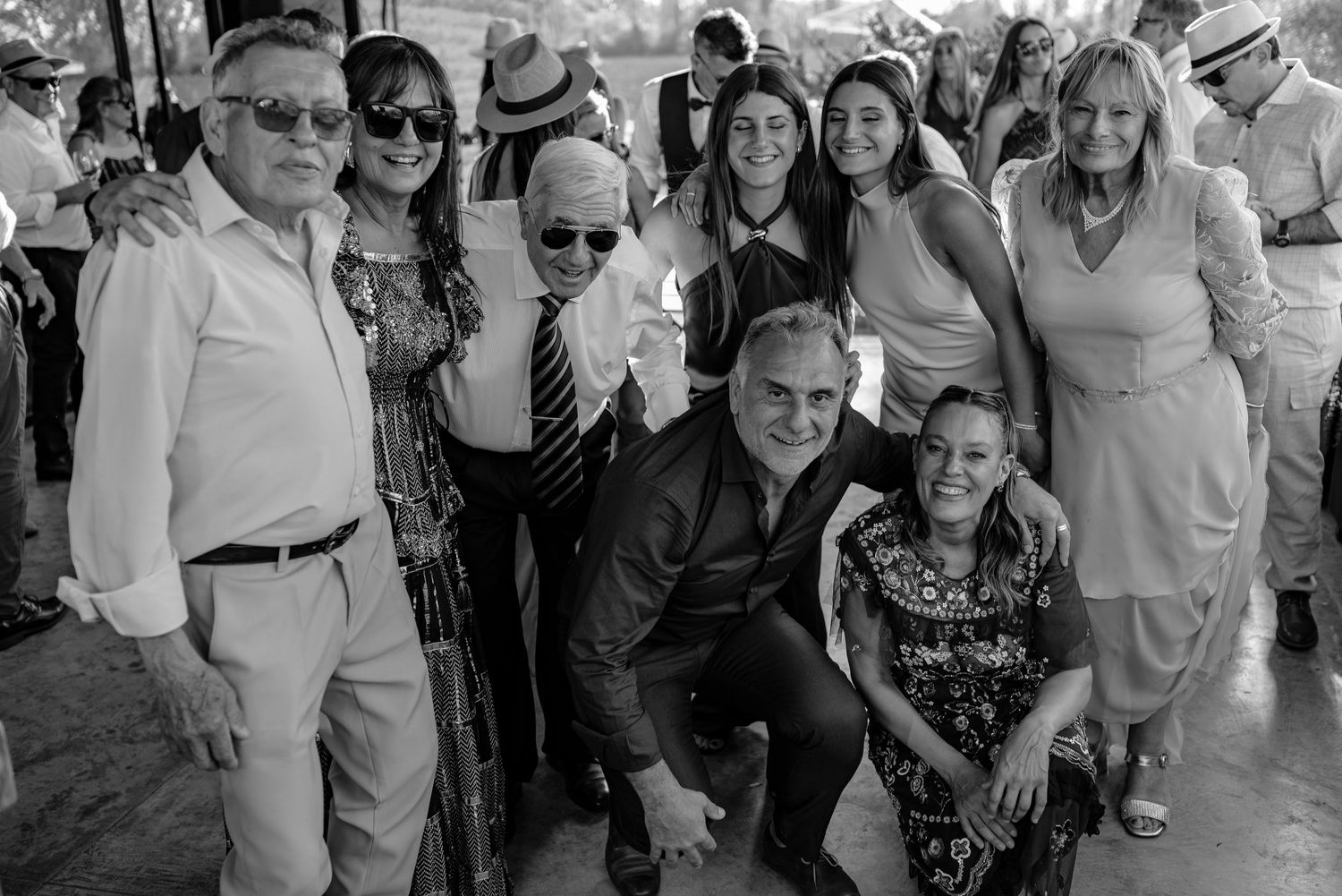 A large crowd of people dancing together at what appears to be a social gathering or celebration event.
