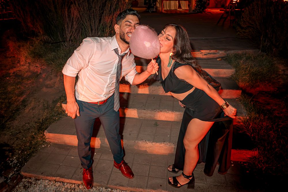 A couple in casual evening attire share a romantic moment while posing on outdoor steps at night. wedding in mendoza