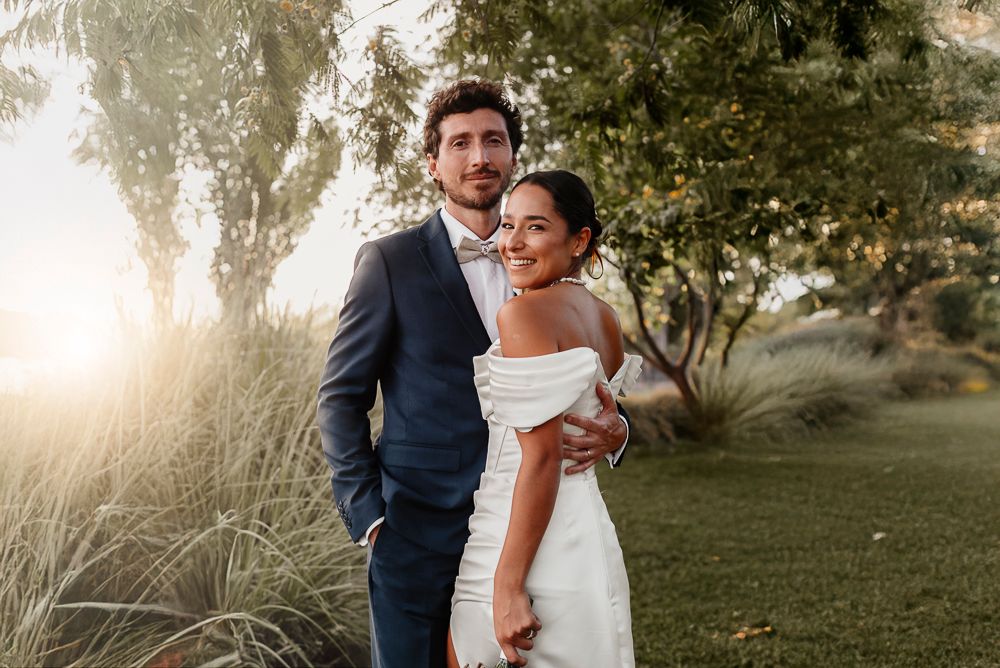 A couple embraces outdoors during sunset in a romantic wedding photoshoot. wedding in mendoza