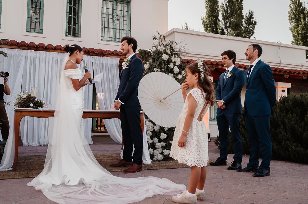 Wedding celebration sequence showing guests and wedding party on a stone patio with white decor. wedding in mendoza