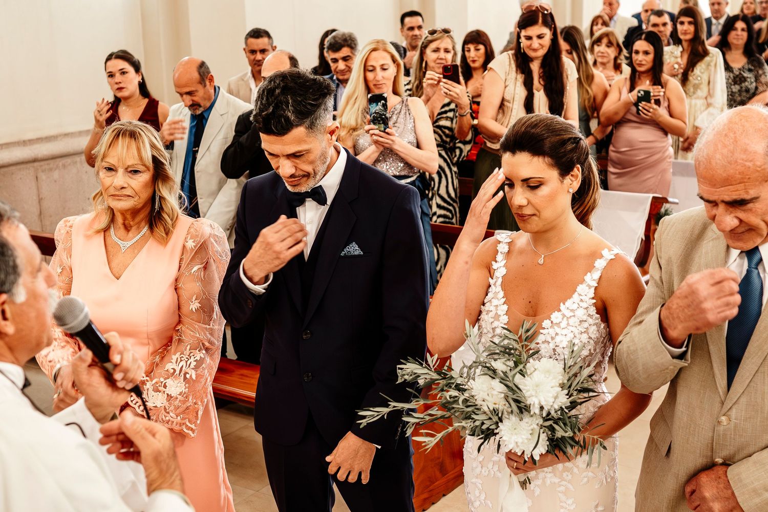 Emotional wedding ceremony scene with guests and couple reacting during touching moment in church.