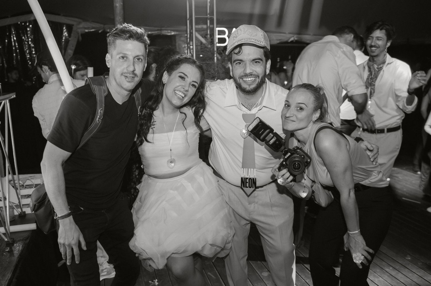 A group of people enjoying drinks and laughs at a lively bar or nightclub gathering.