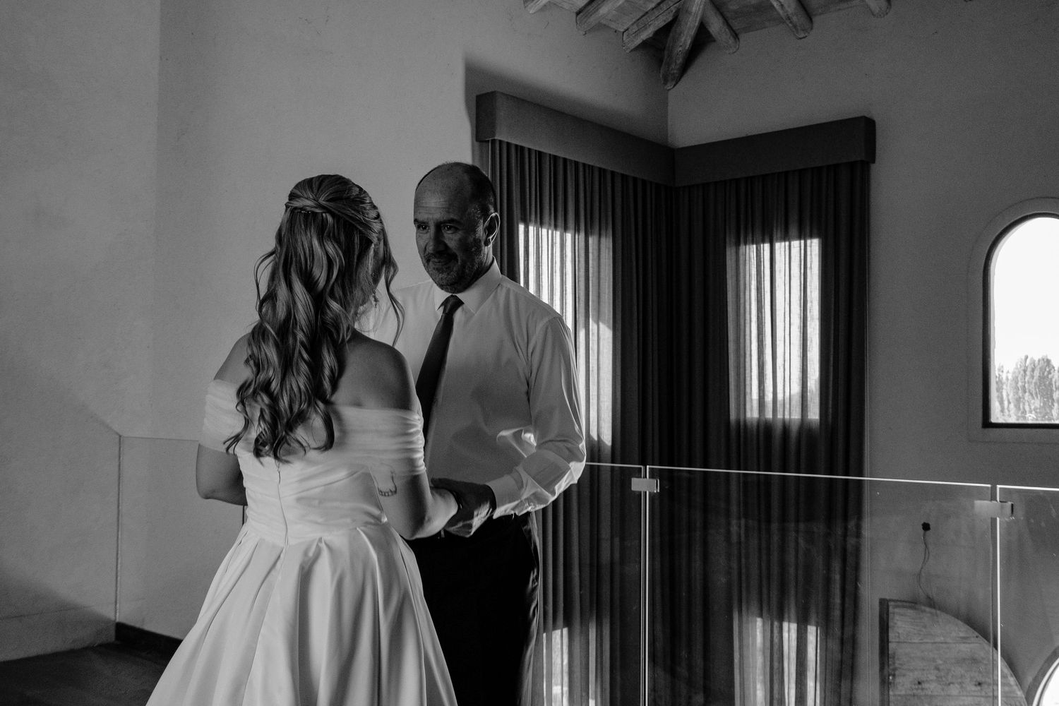A black and white collage of wedding moments showing a couple dancing, embracing, and walking together in formal attire.