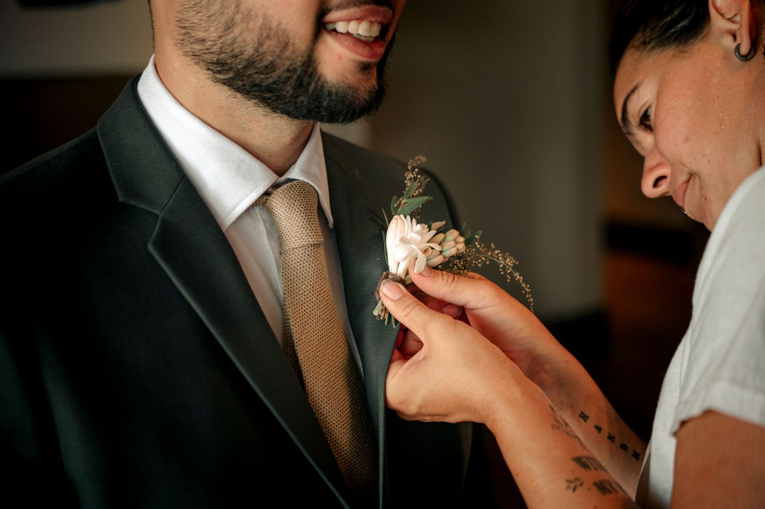 A couple sharing an intimate moment during their wedding reception while eating cake together.