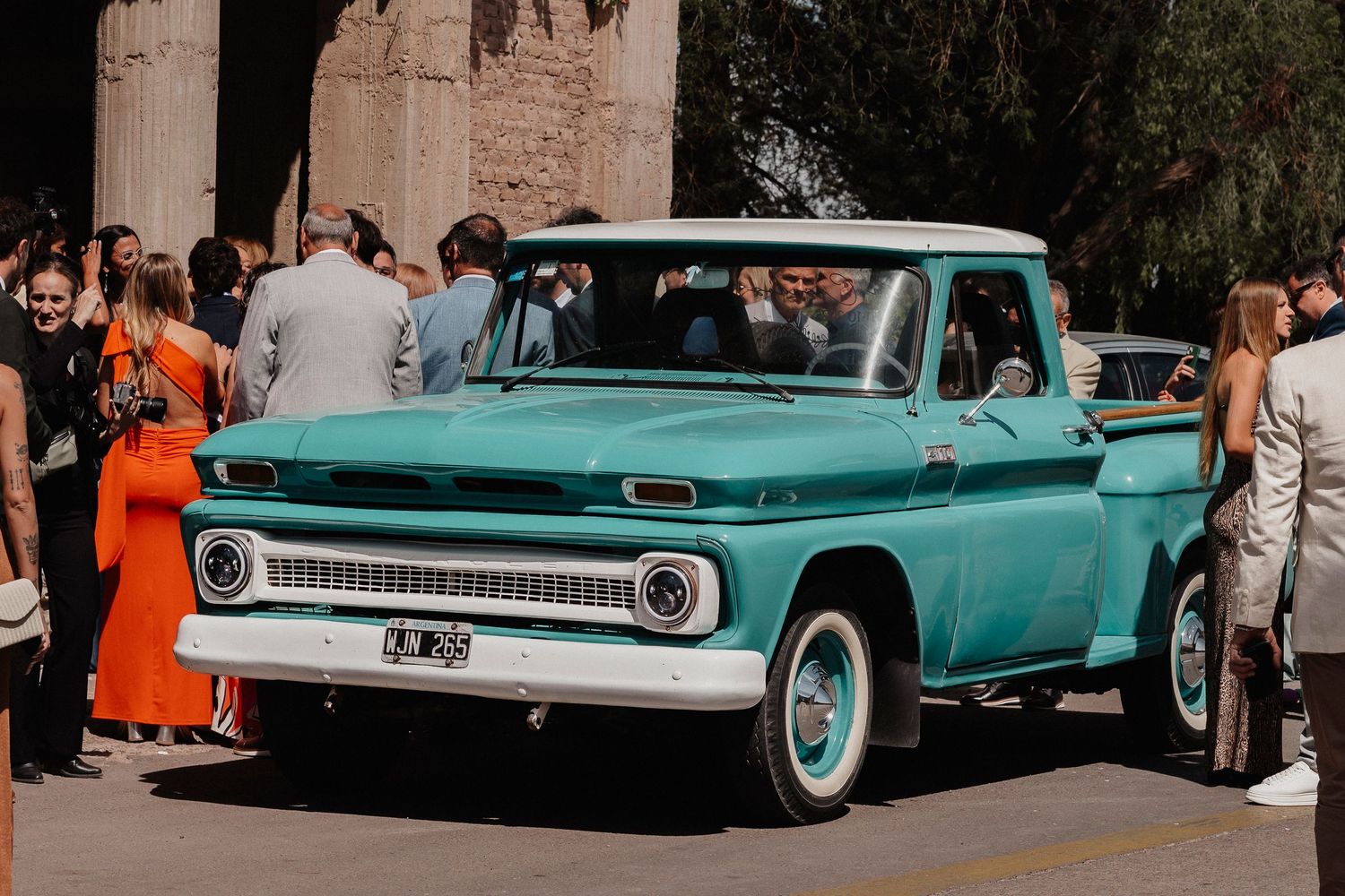Vintage turquoise Thunderbird classic cars lined up at a retro car show with spectators admiring the display.