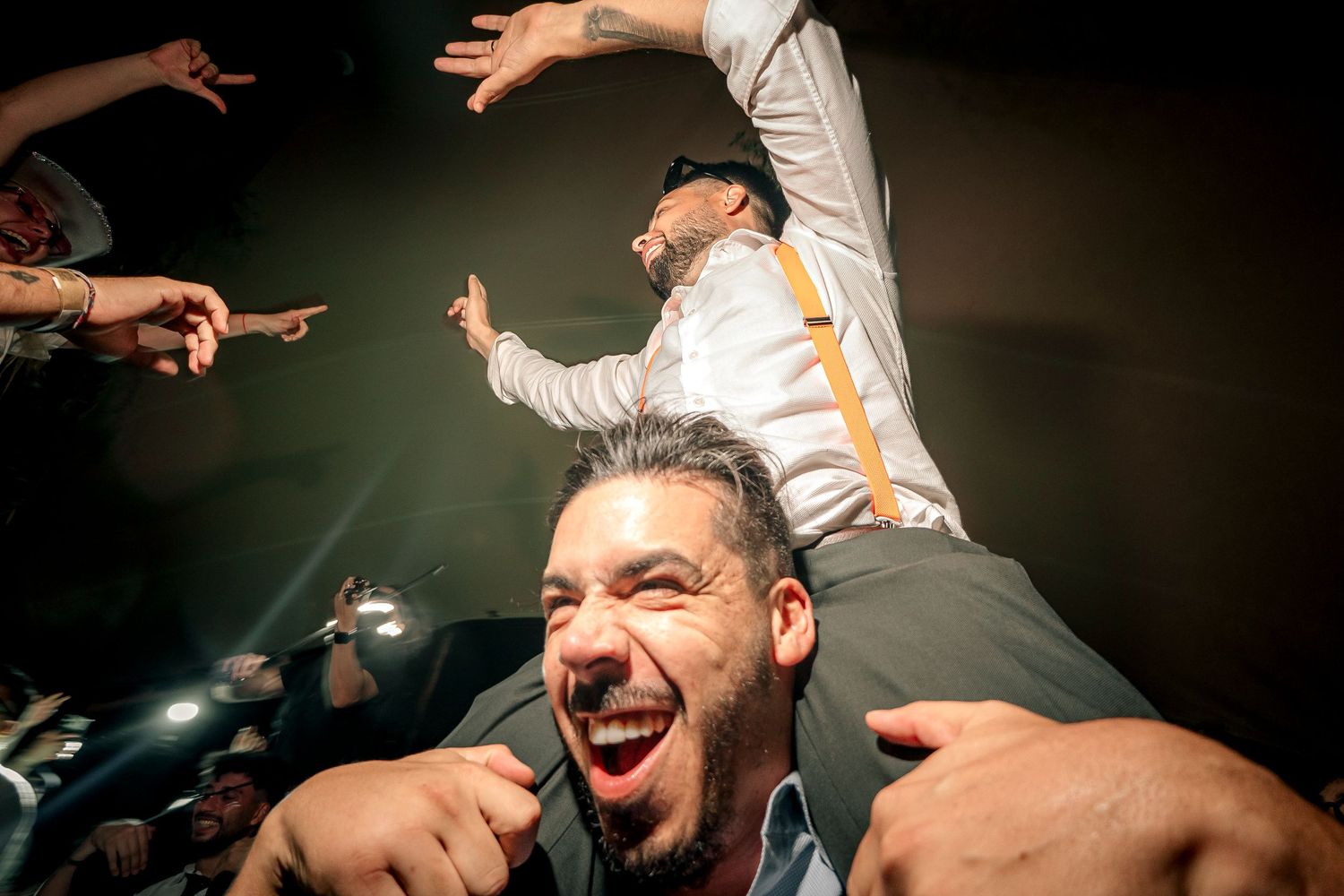 Energetic concert performance with dynamic stage lighting and enthusiastic crowd interaction.