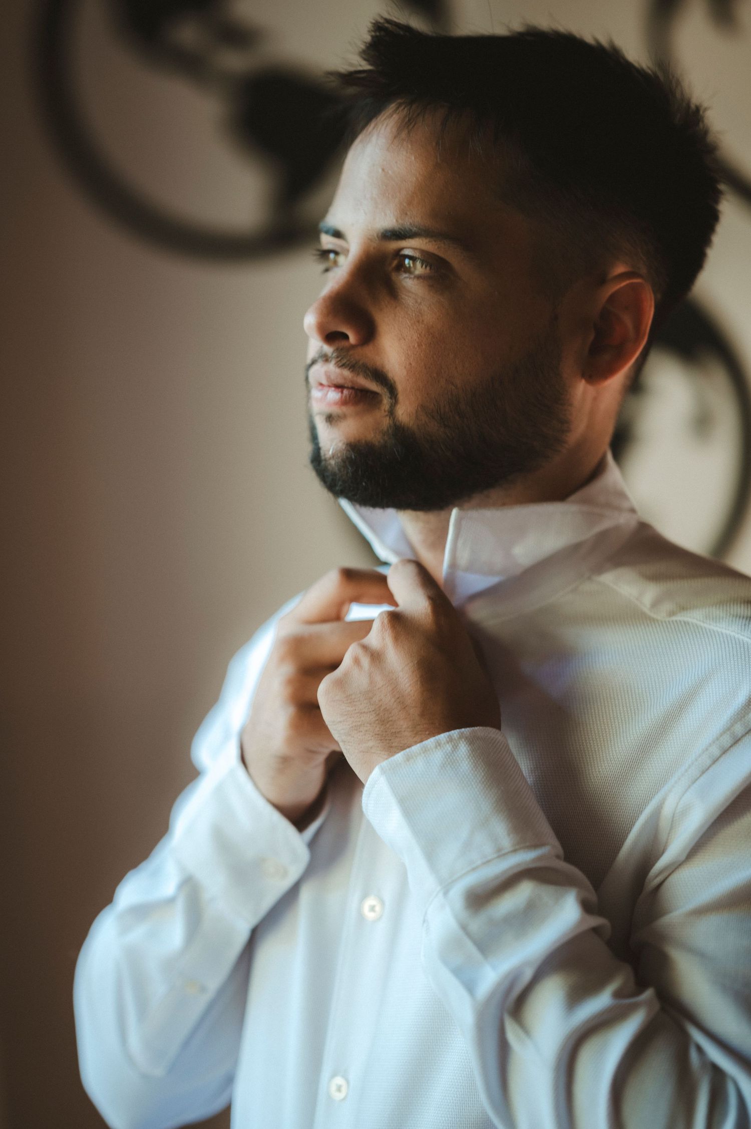 A sequence of photos showing someone adjusting a white dress shirt collar in profile view against a neutral background.